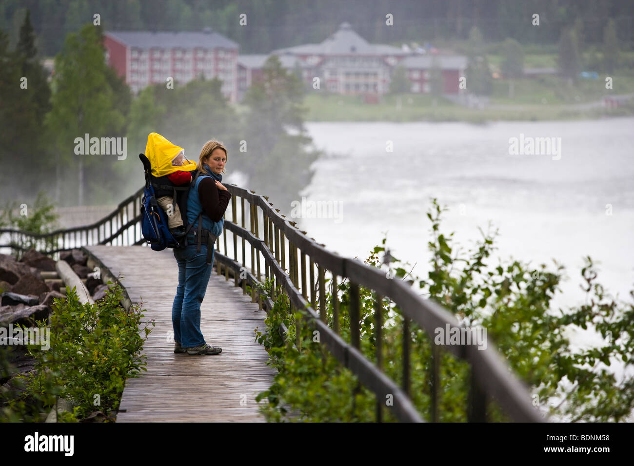 Woman carrying child piggy-back at Storforsen Waterfall, Norbottens Lan, Sweden Stock Photo