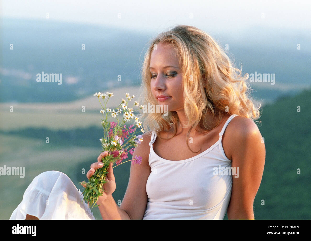 beautiful woman with bunch of wildflowers Stock Photo