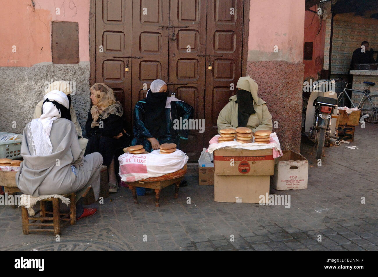 Poor Veiled Moroccan Arabic Muslim Women Selling Bread on the Street in