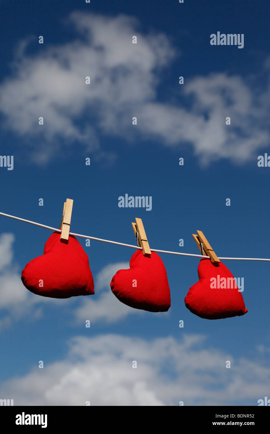 Heart shaped bean bags on a washing line against a summer sky