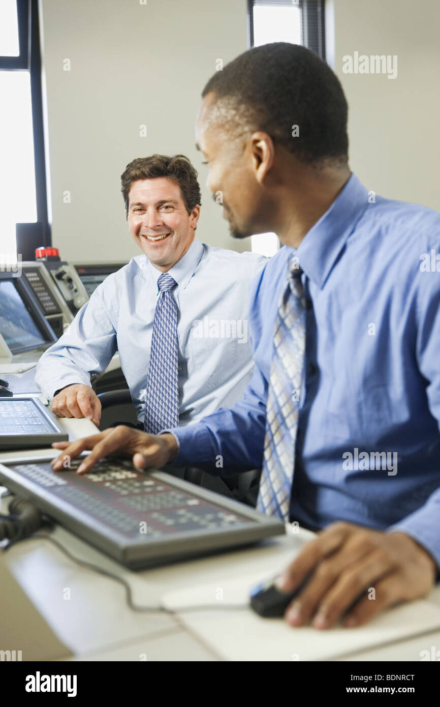 Two operating engineers working in a control room Stock Photo Alamy
