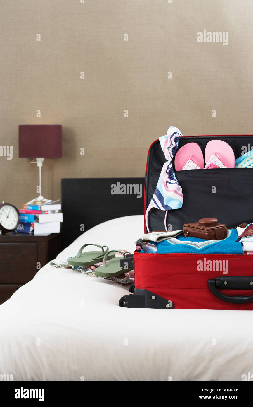 Open suitcase on bed Stock Photo Alamy