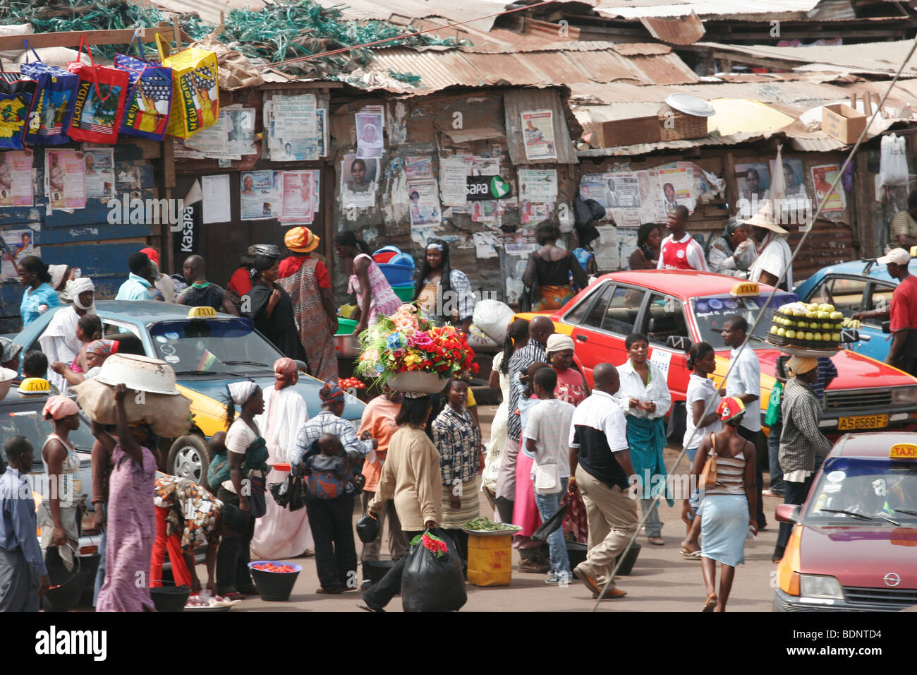 People carrying goods on their heads in the very busy Kejetia Market in central Kumasi. Ghana. West Africa. Stock Photo
