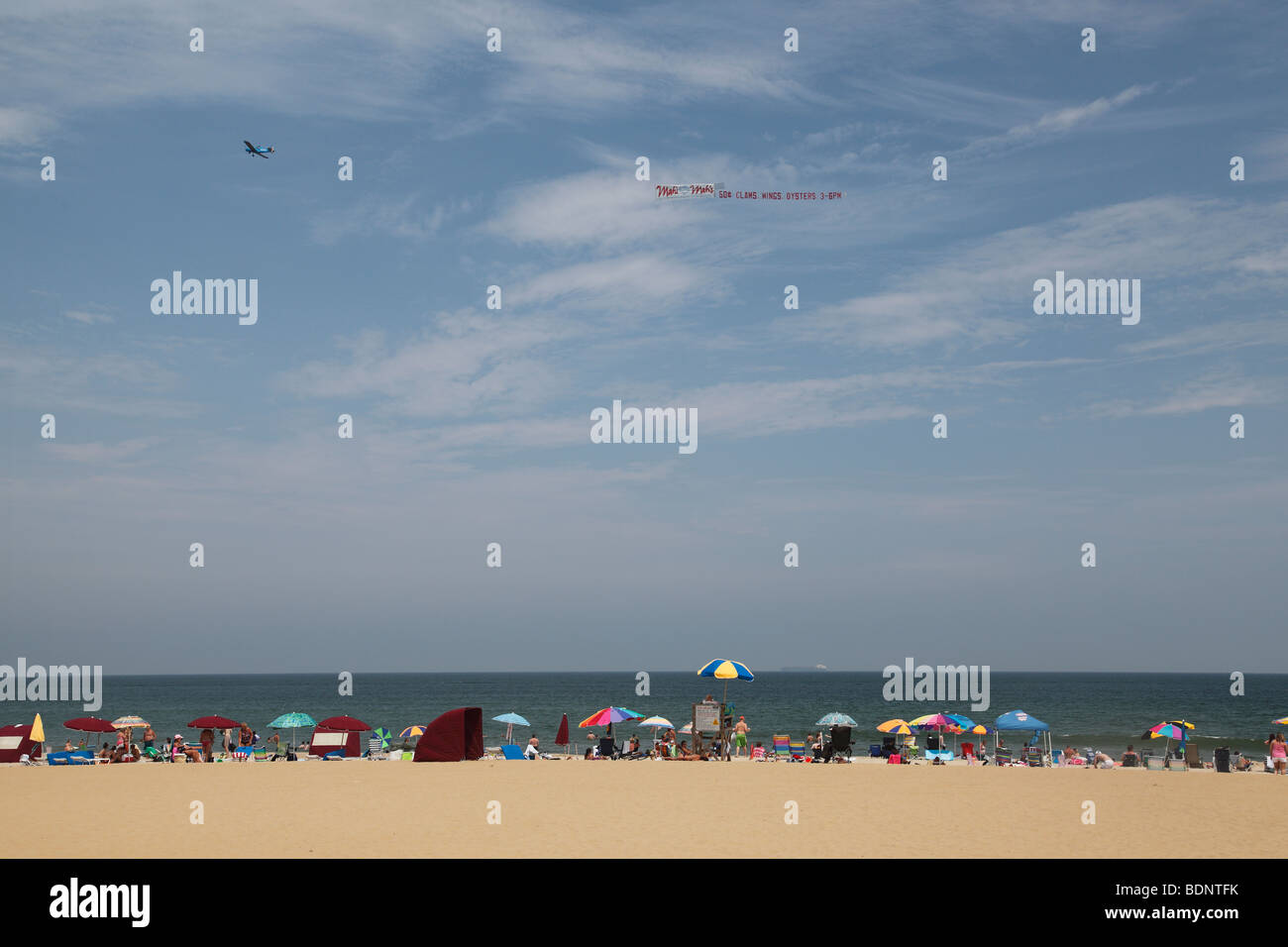 Airplane towing an advertising banner over Virginia Beach, VA Stock