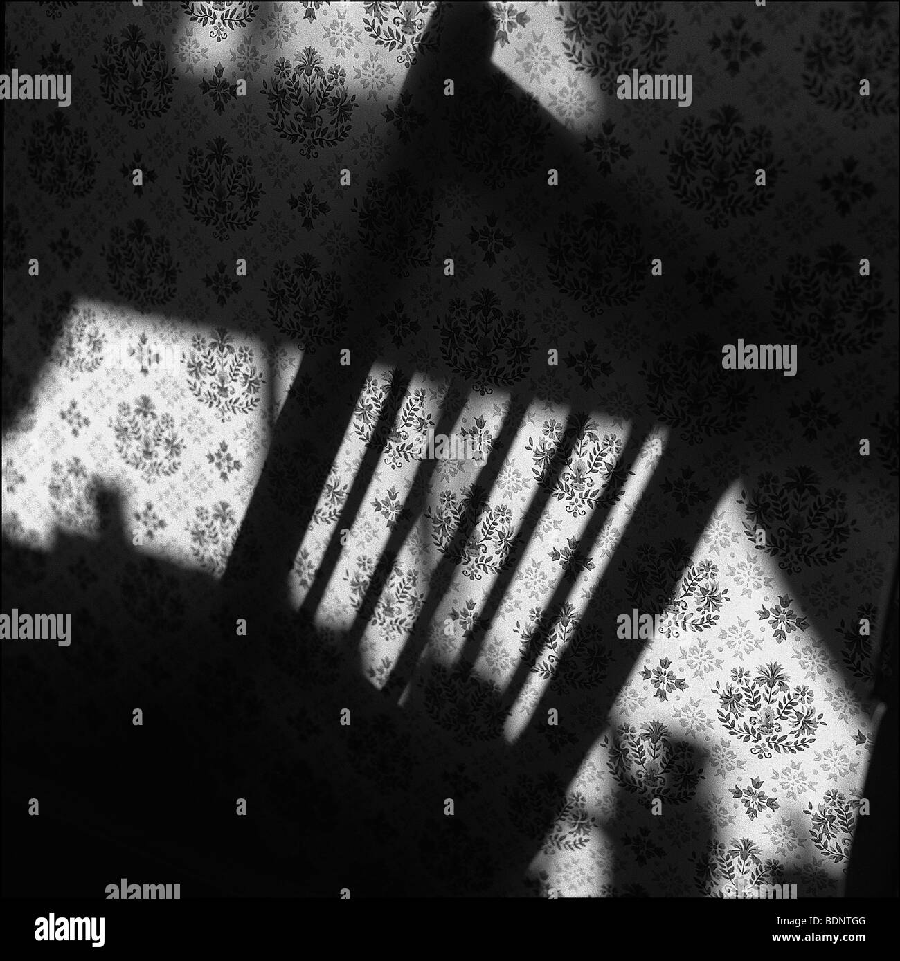 The shadow of a chair on wallpaper Stock Photo - Alamy