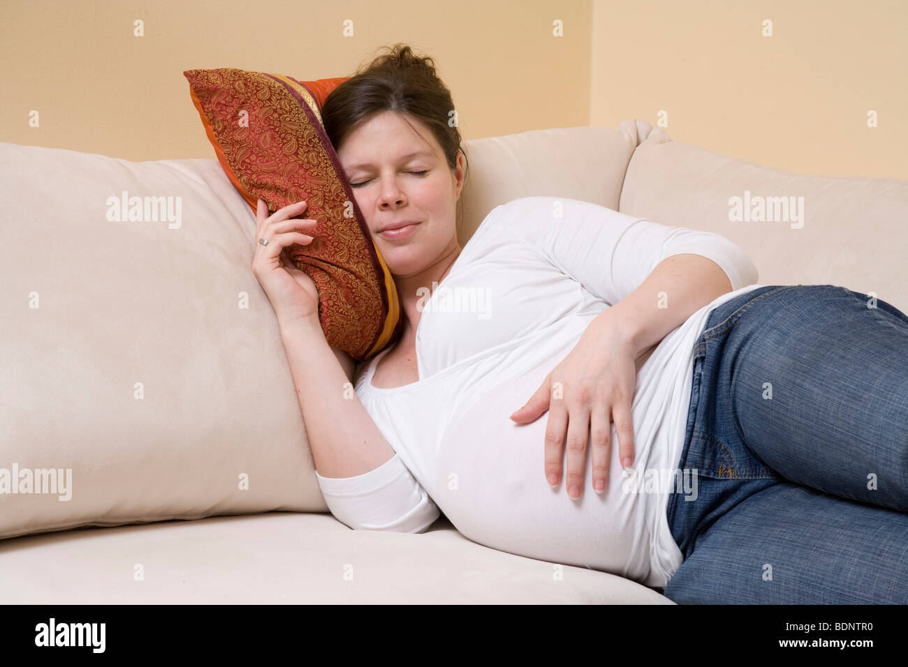 Pregnant woman sleeping on a sofa Stock Photo Alamy