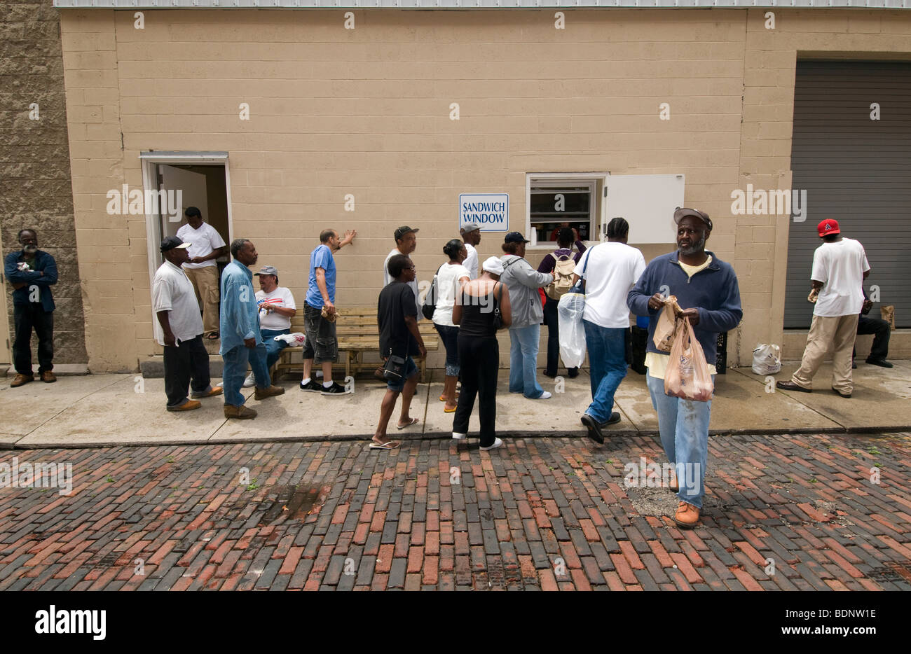 People queing at Sandwich window, Cincinnati, OH, Over the Rhine, area of redevelopment, Stock Photo
