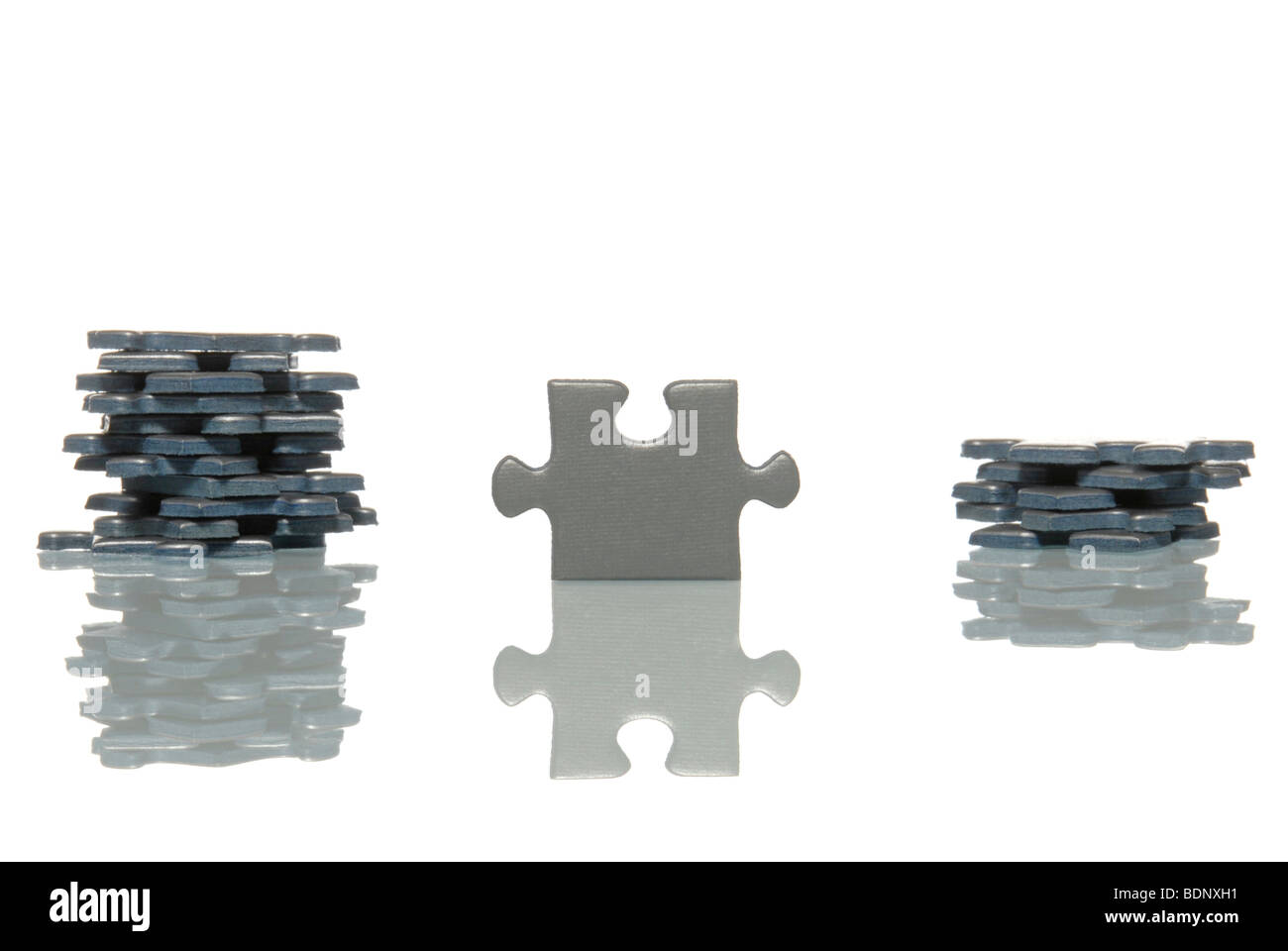 A standing puzzle piece with two stacks of puzzle pieces, symbolic picture for team selection Stock Photo