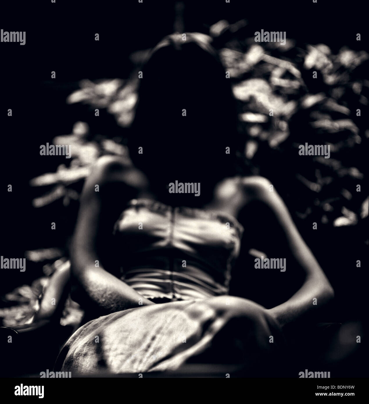 Unknown woman seated hi-res stock photography and images - Alamy