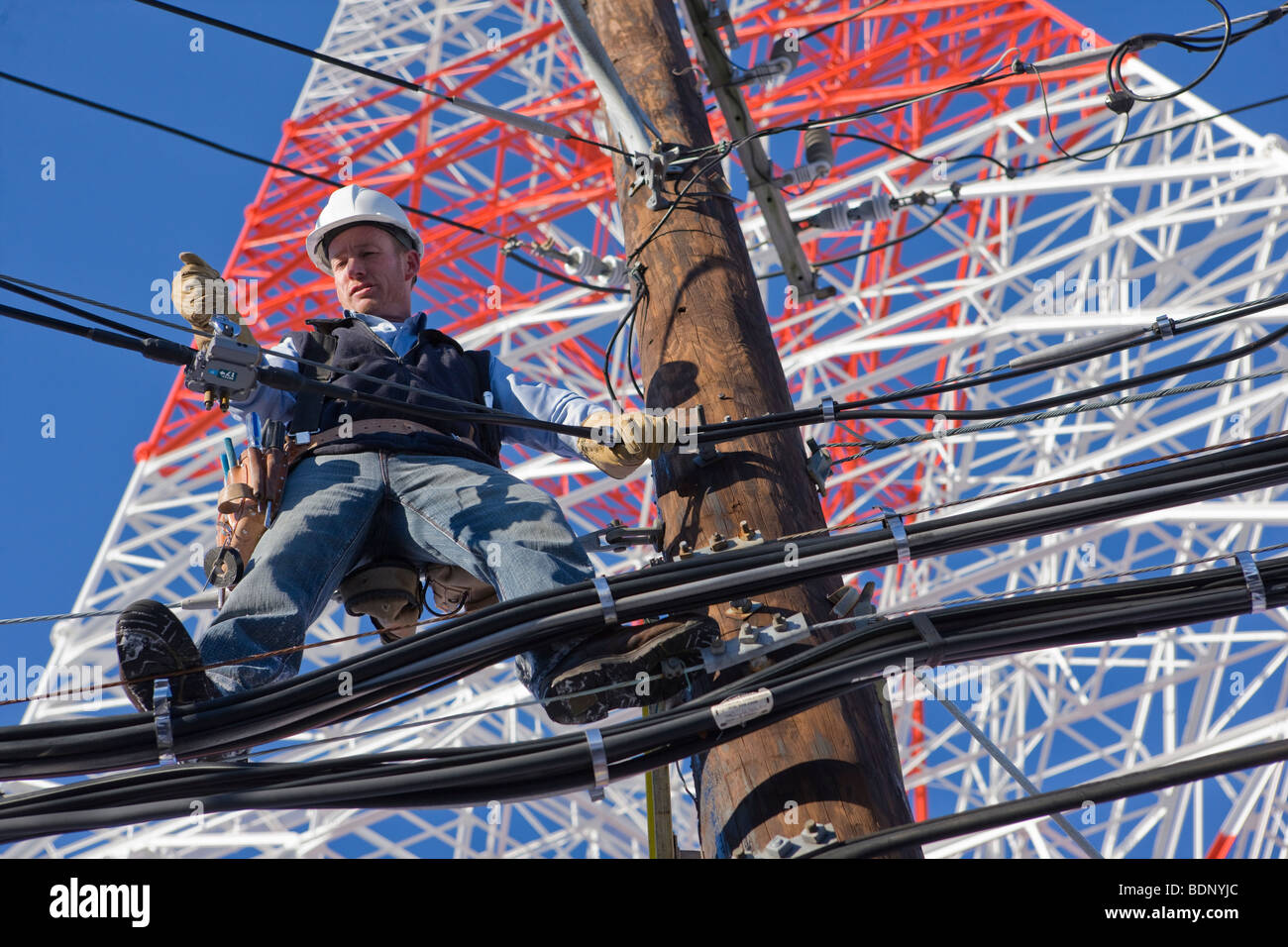Cable lineman repairing transmission line Stock Photo Alamy