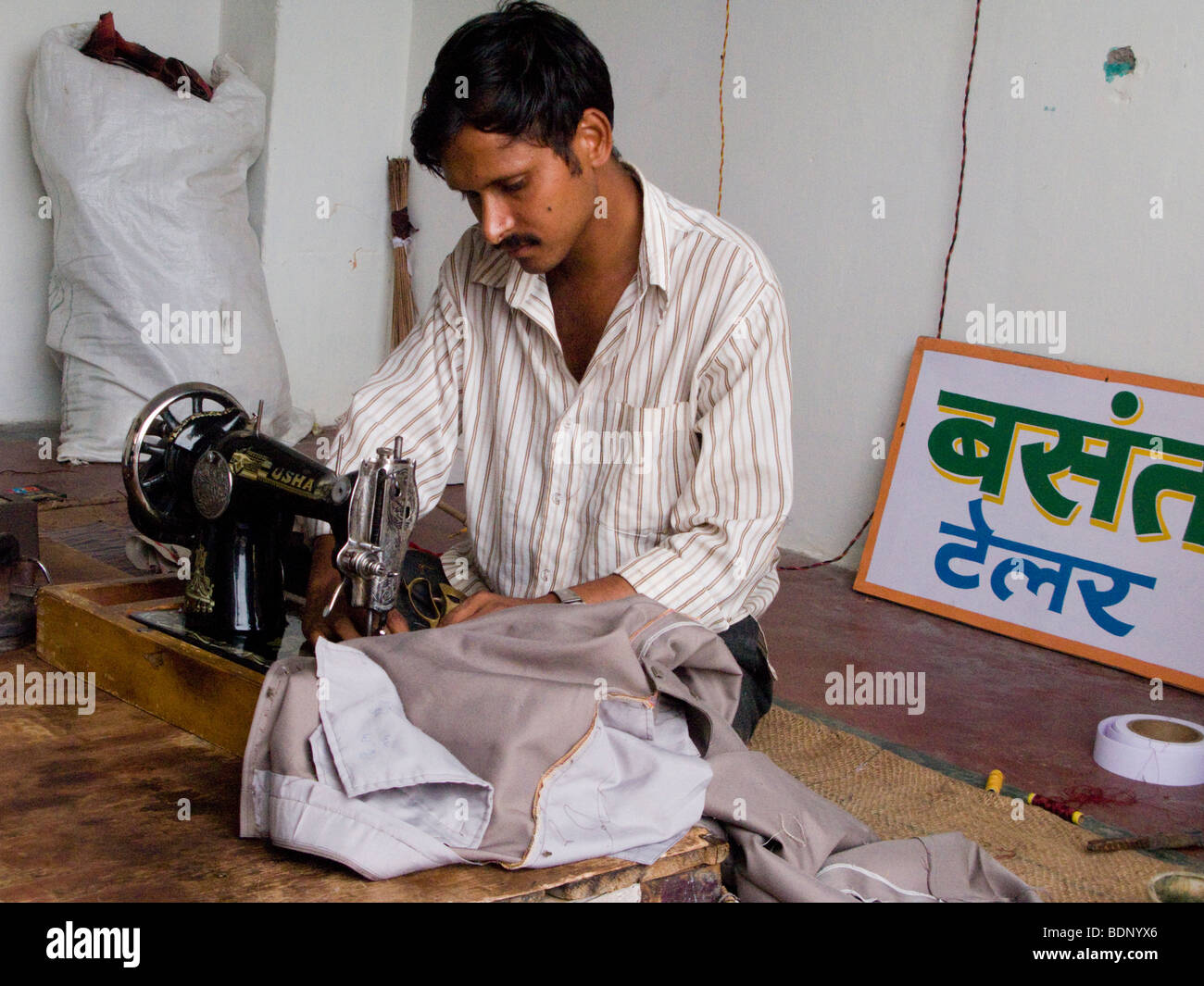 Tailor working on a sewing machine in a tailors shop in Rewalsar