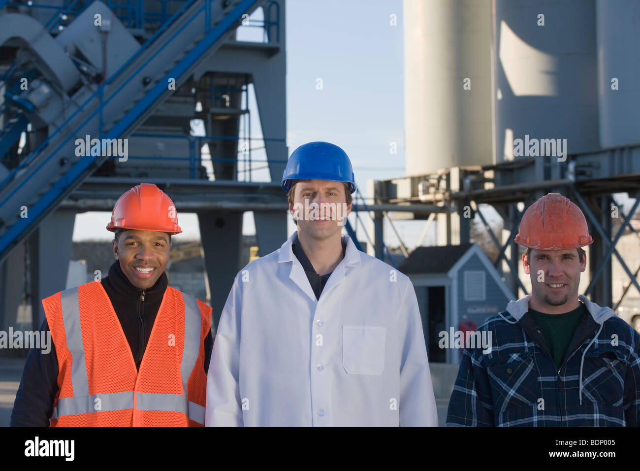 Lab worker with two engineers at an asphalt plant Stock Photo