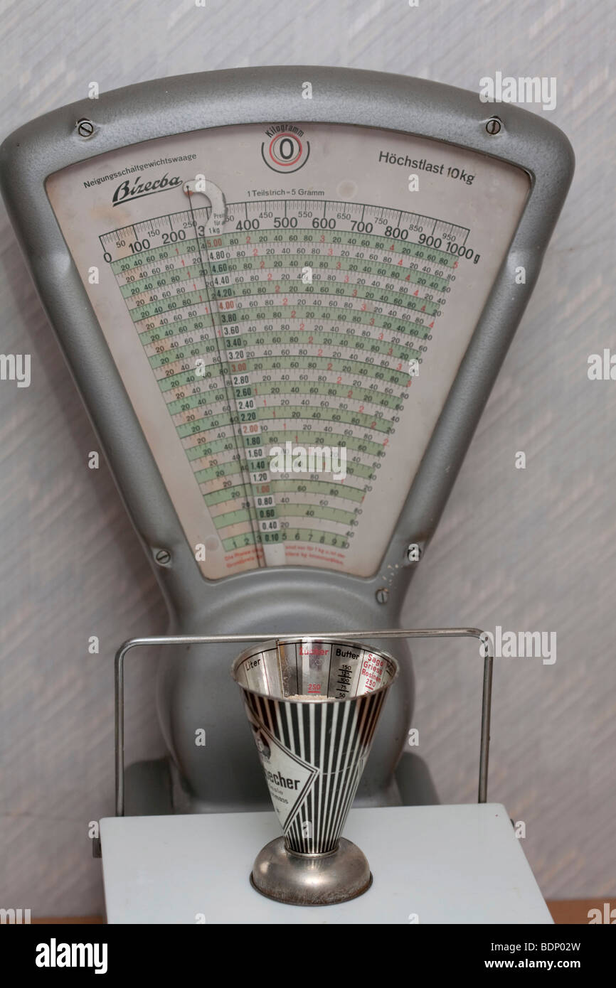 Measuring cup with brown sugar, on a kitchen scale Stock Photo Alamy