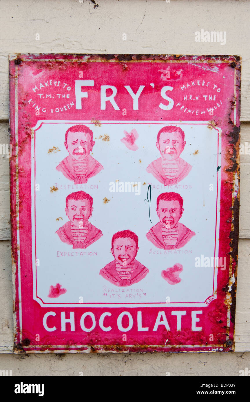 An old weathered sign on a Uk railway station advertising Fry's chocolate Stock Photo
