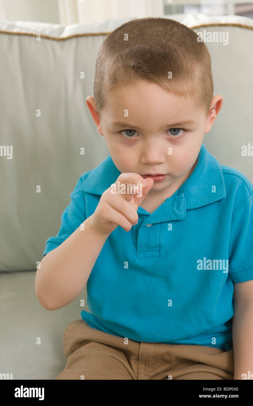 Boy signing the letter 'R' in American Sign Language Stock Photo