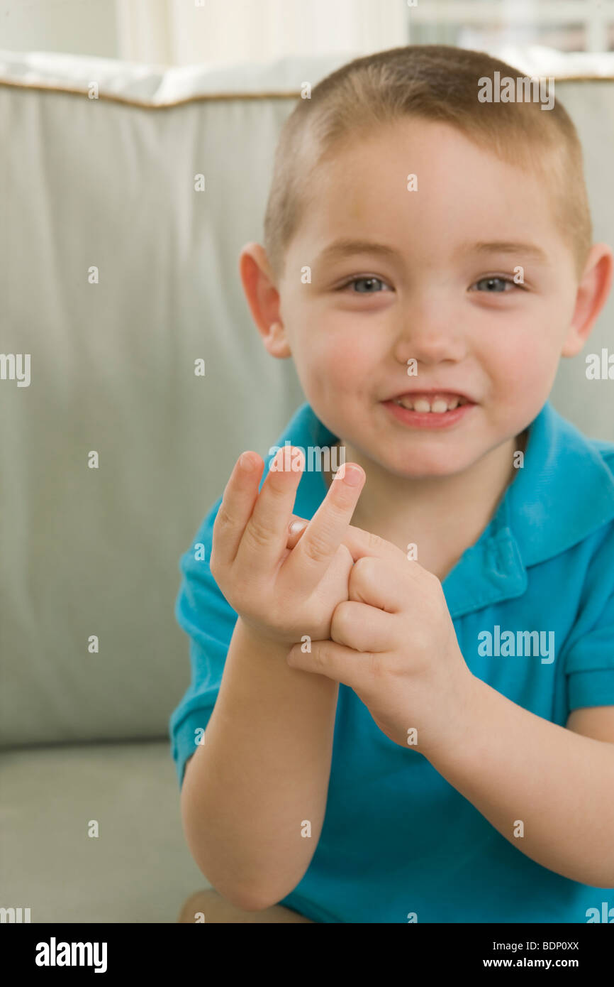 Boy signing the letter 'W' in American Sign Language Stock Photo
