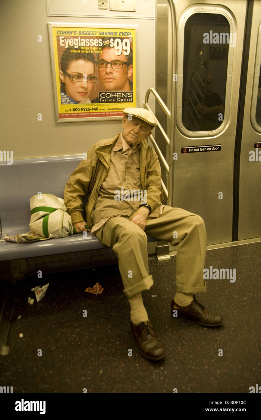 A tired elderly man rides the F train in Brooklyn, New York. Stock Photo