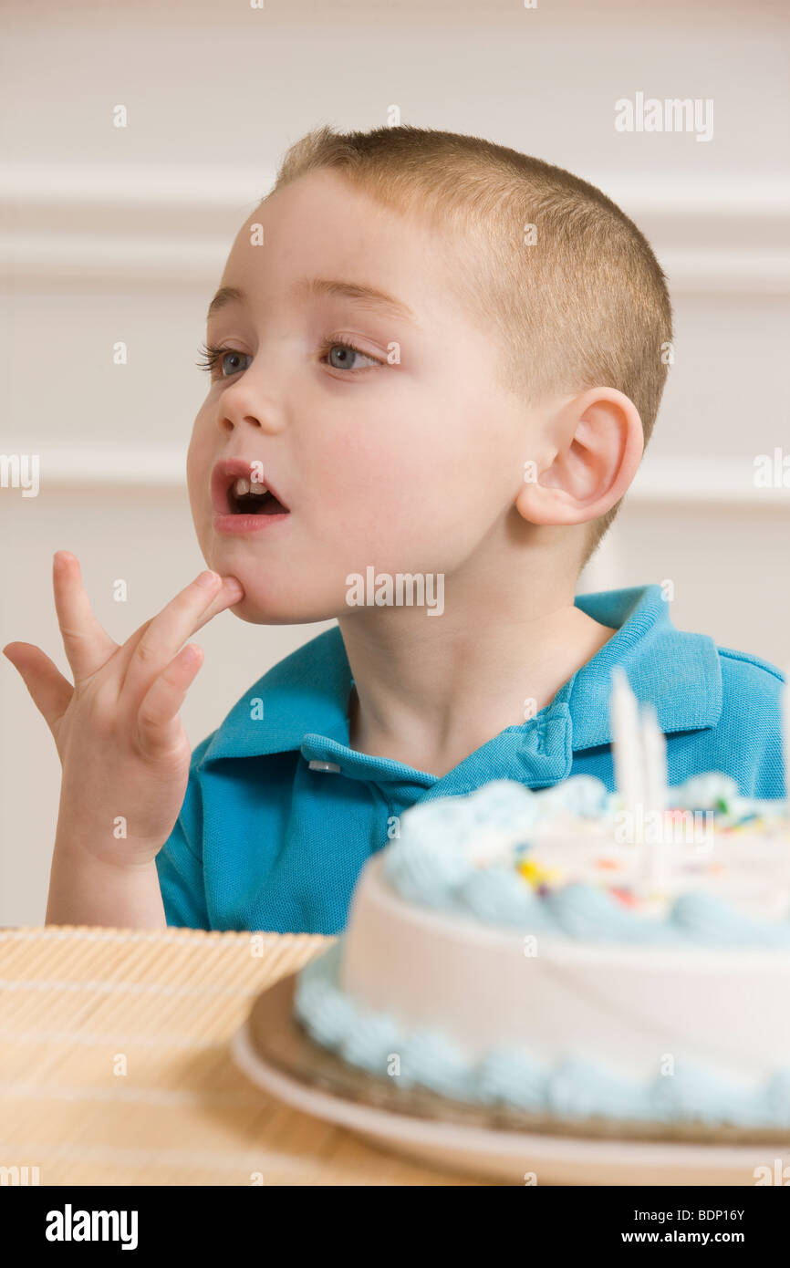 Boy signing the word 'Birthday' in American Sign Language sitting in