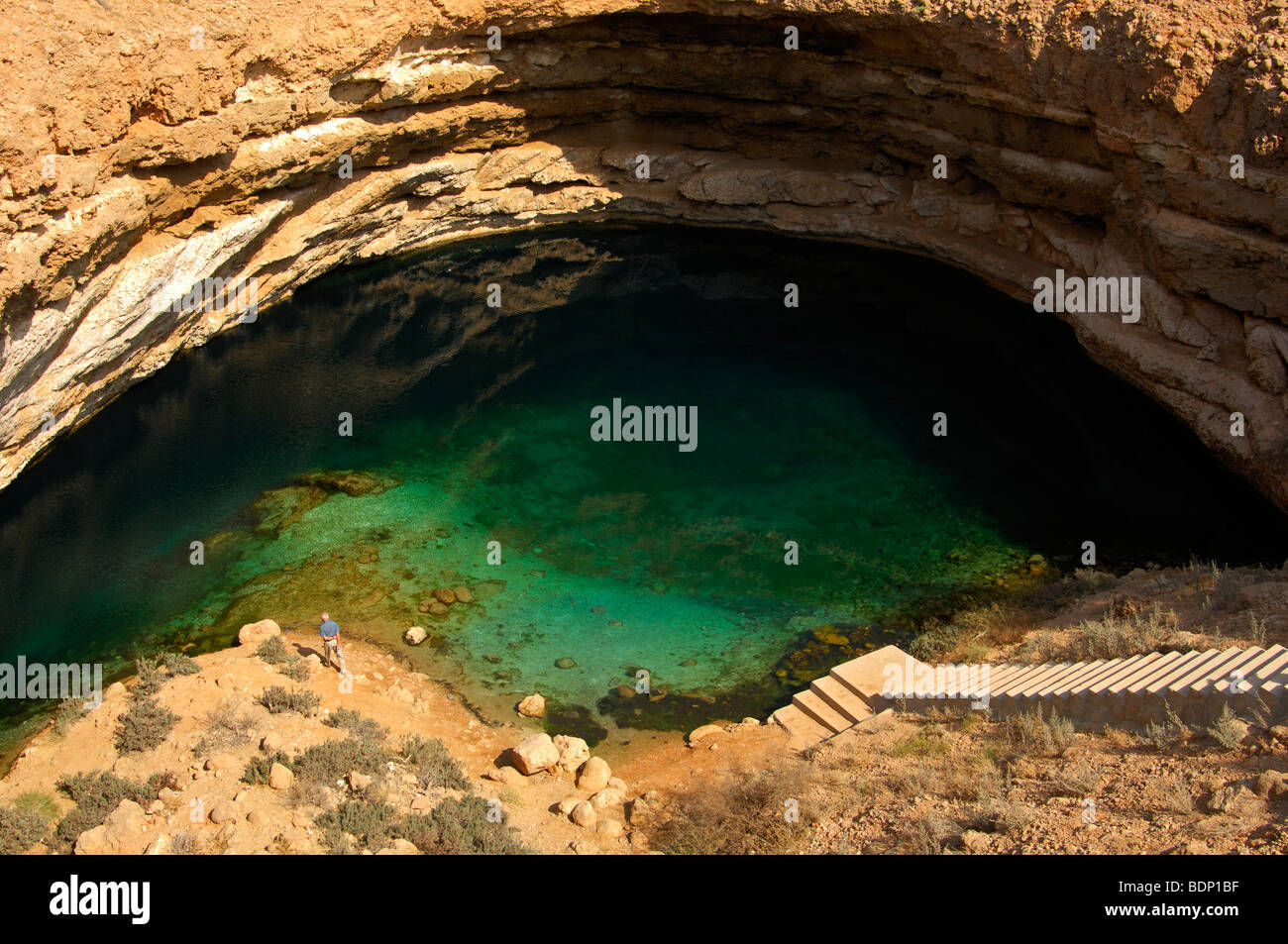 Turquoise water on the base of a limestone crater, Dibab Lake Park, Bamah, Sultanate of Oman, Near East Stock Photo