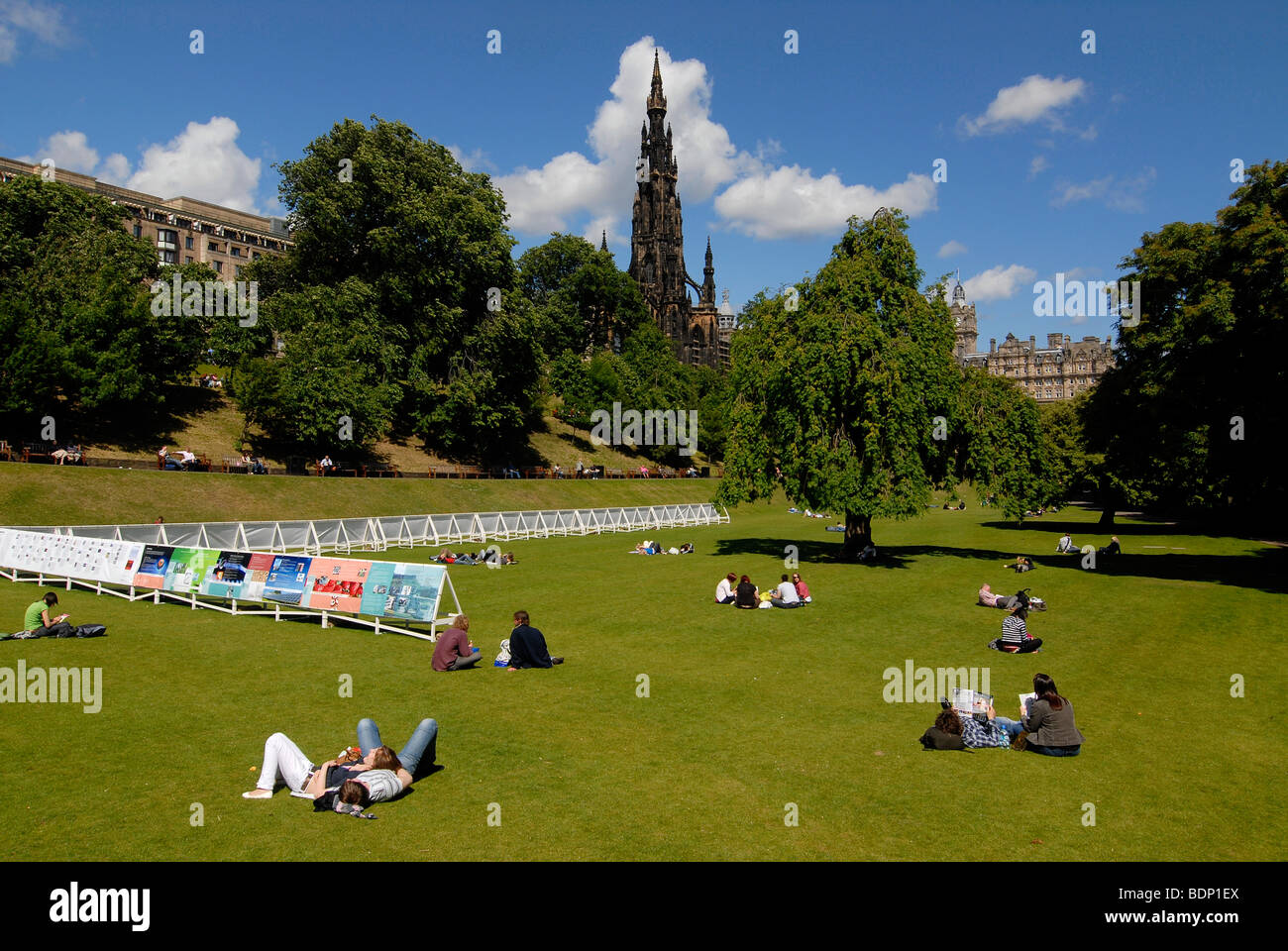 People relaxing in a park, in front of the Scott Monument in Edinburgh, Scotland, UK, Europe Stock Photo