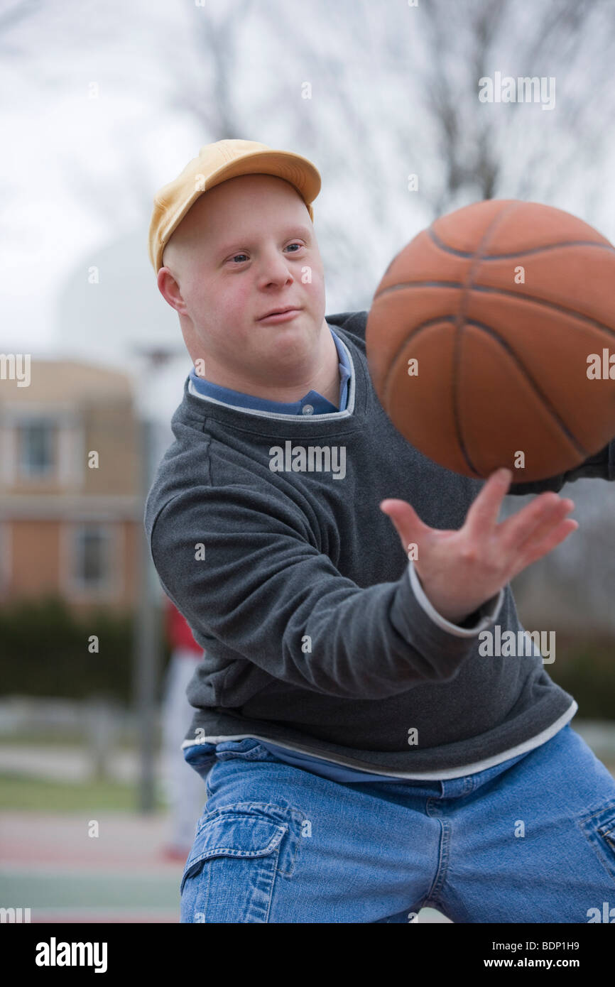 Man spinning basketball on his finger Stock Photo