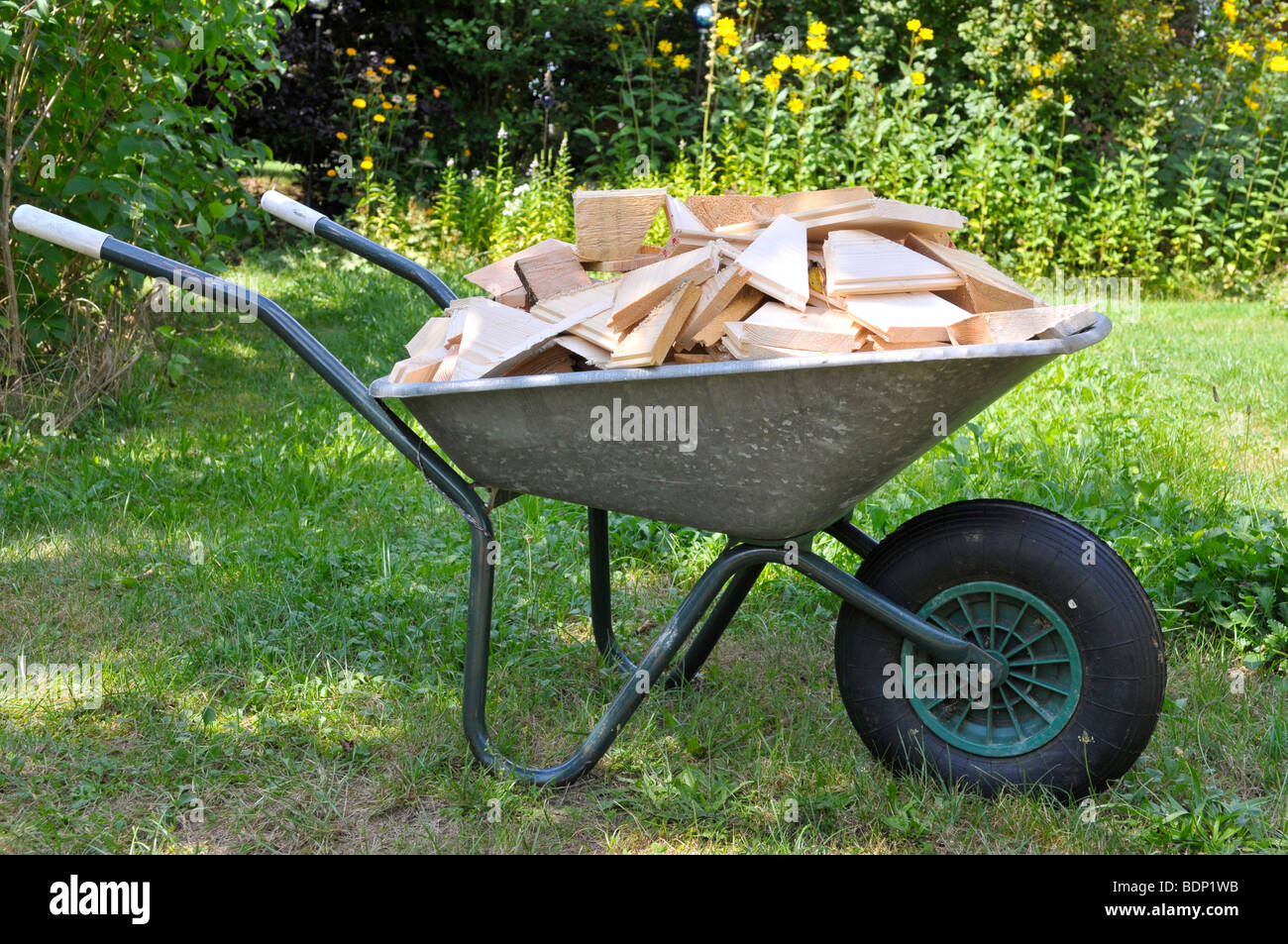 Lumber for firewood in a wheelbarrow Stock Photo - Alamy