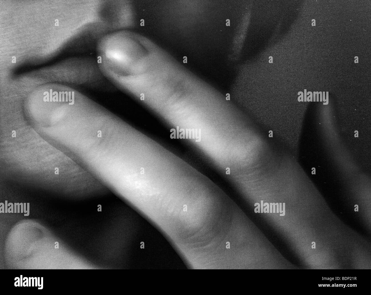 Fingers touching a woman's lips Stock Photo