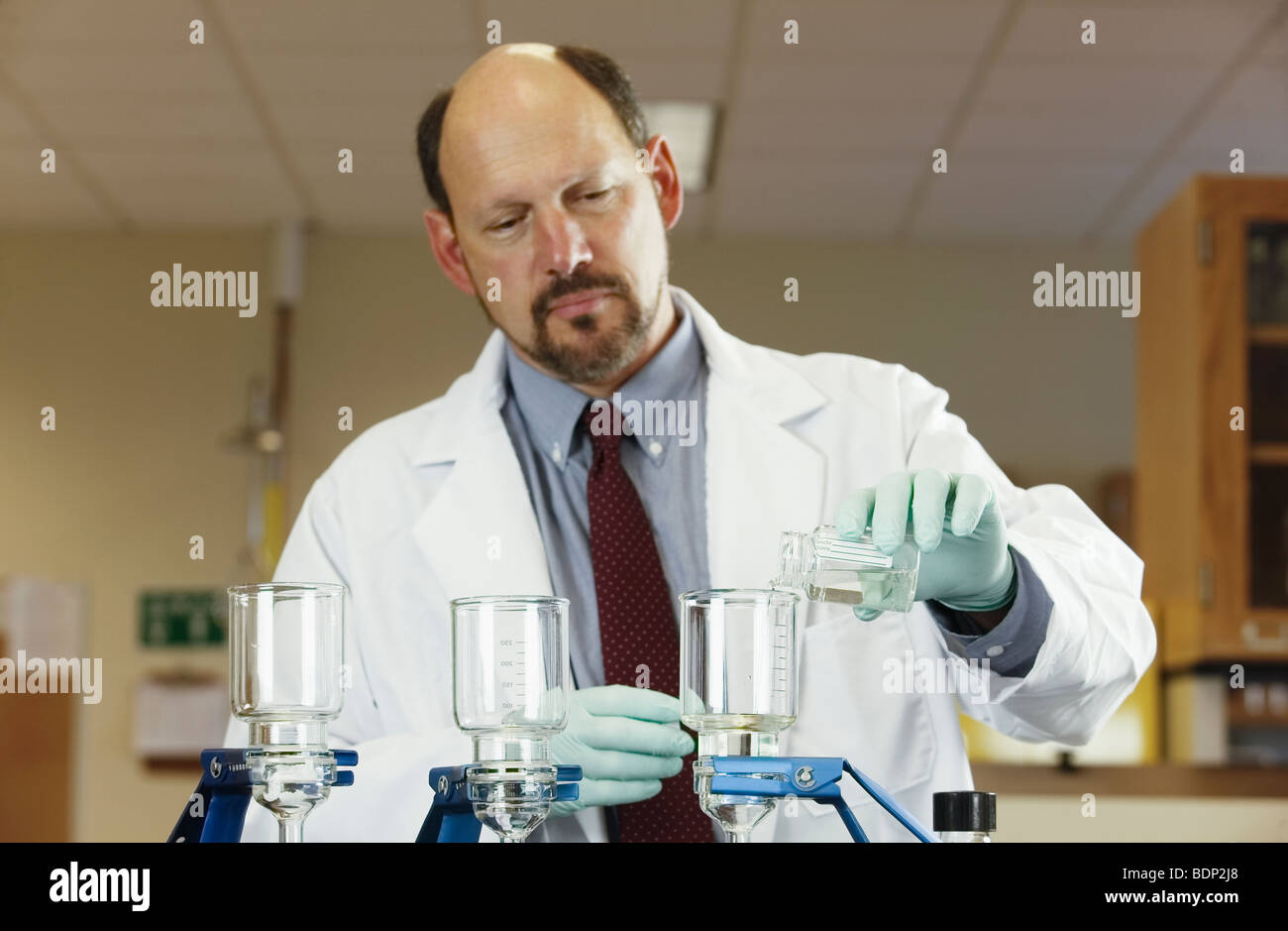Scientist filtering a sample Stock Photo Alamy