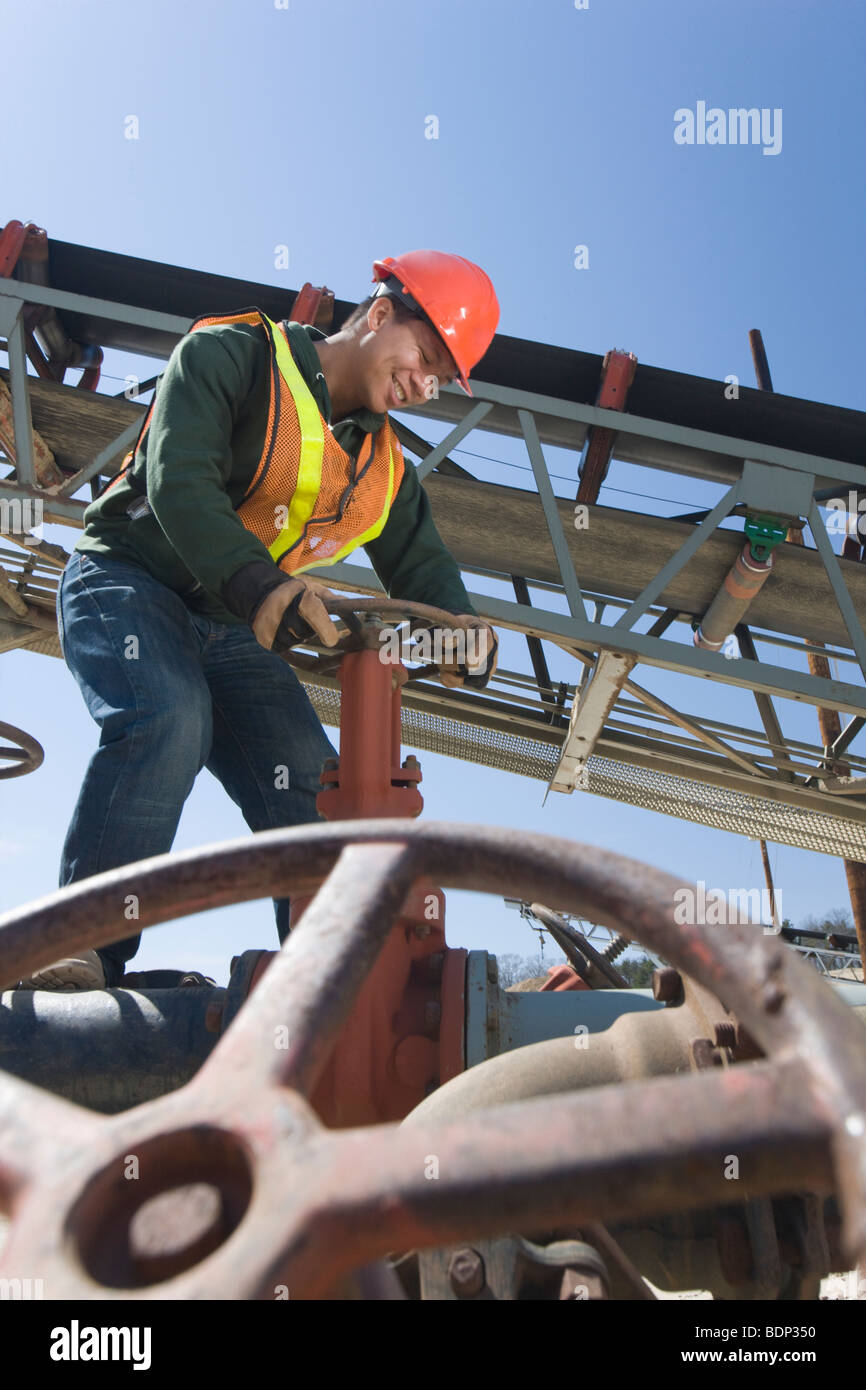 Engineer turning valve at a plant Stock Photo Alamy