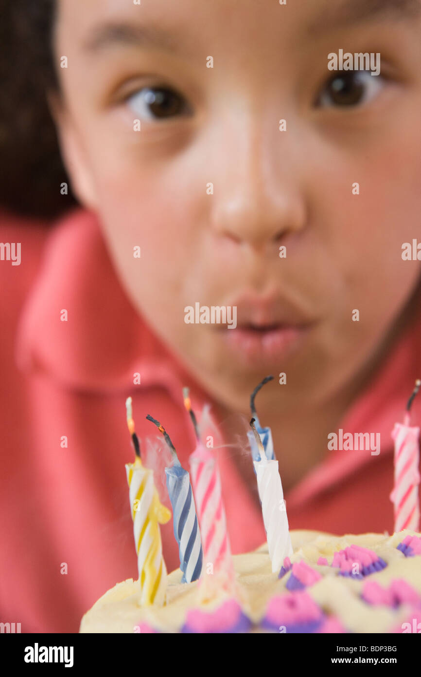 Girl blowing out candles on a birthday cake Stock Photo Alamy