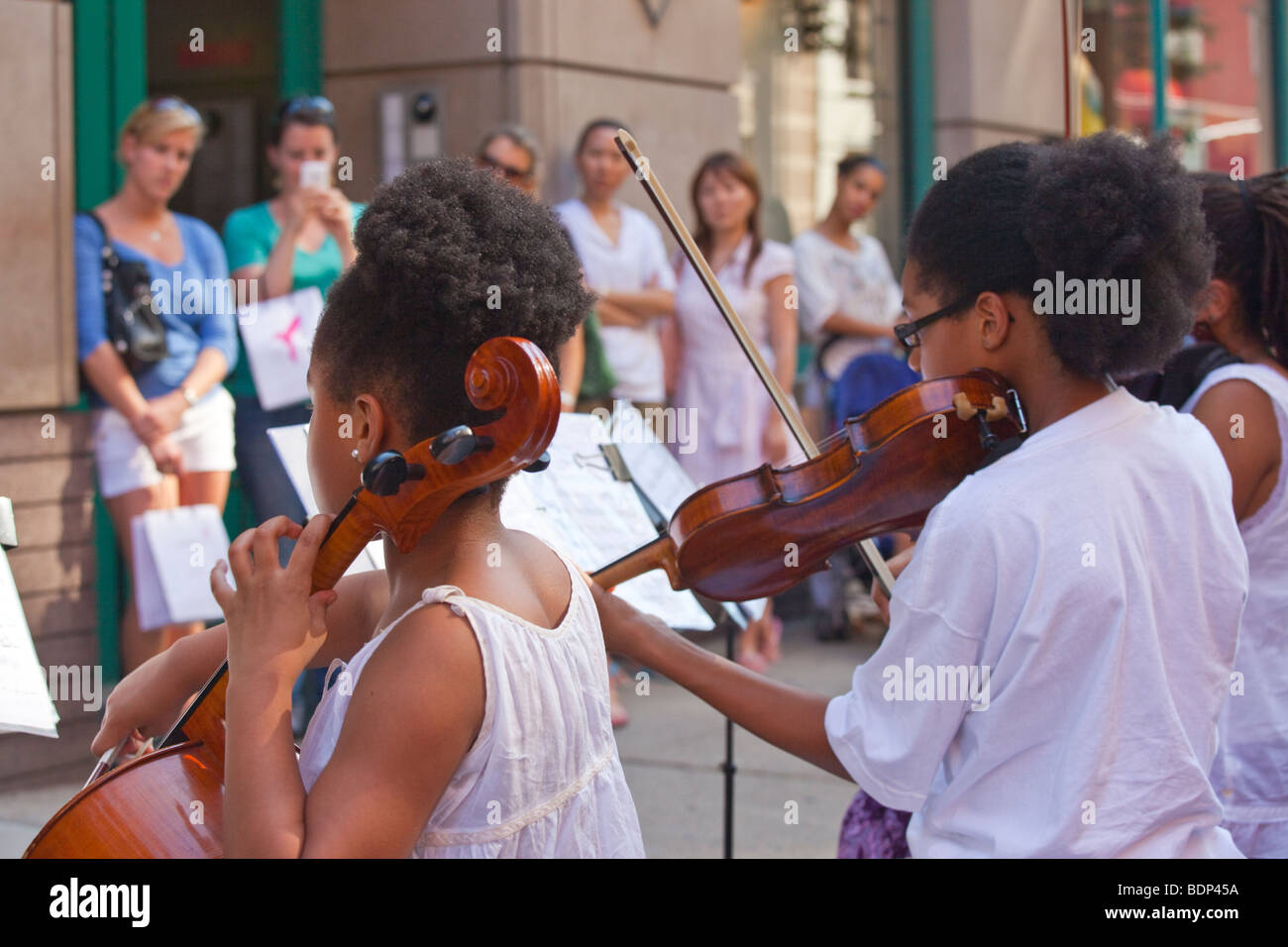 Young African American girls playing classical music on the street in SOHO in New York City Stock Photo