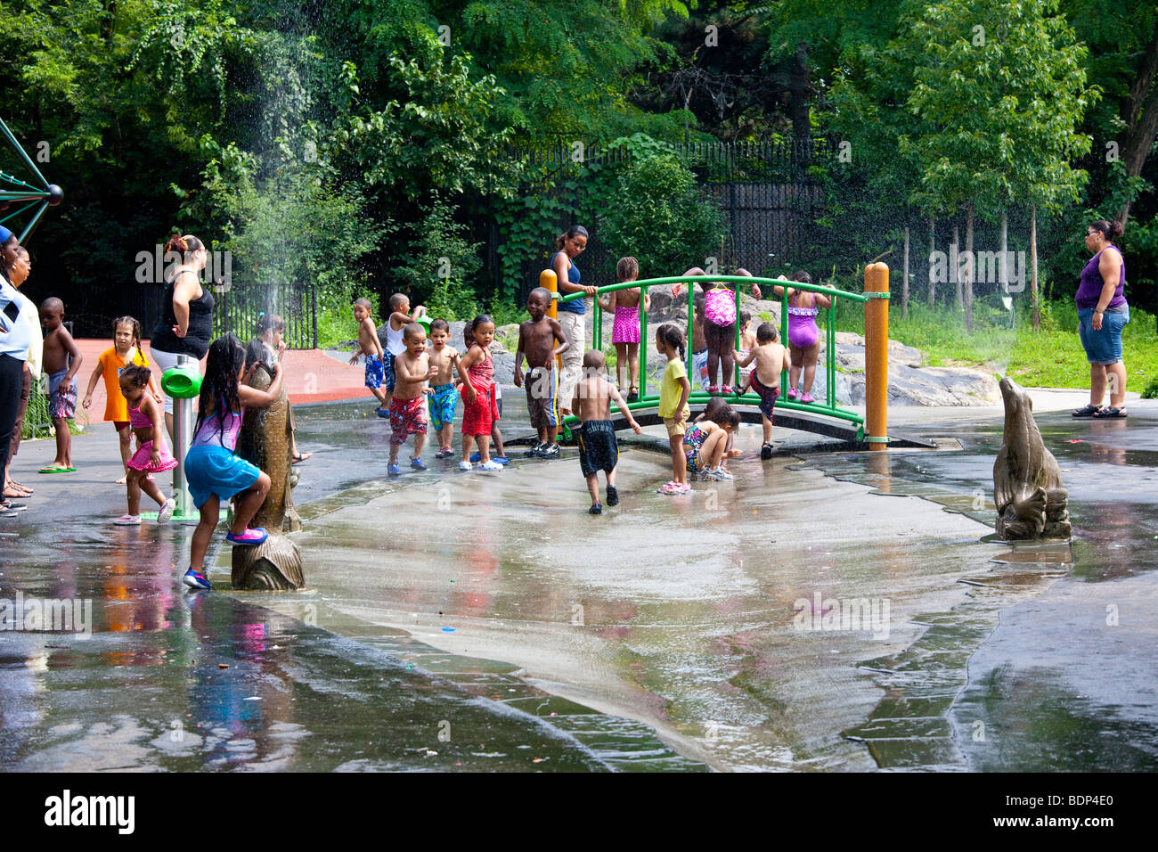 Children playing with water fountains in a park in the Bronx in New