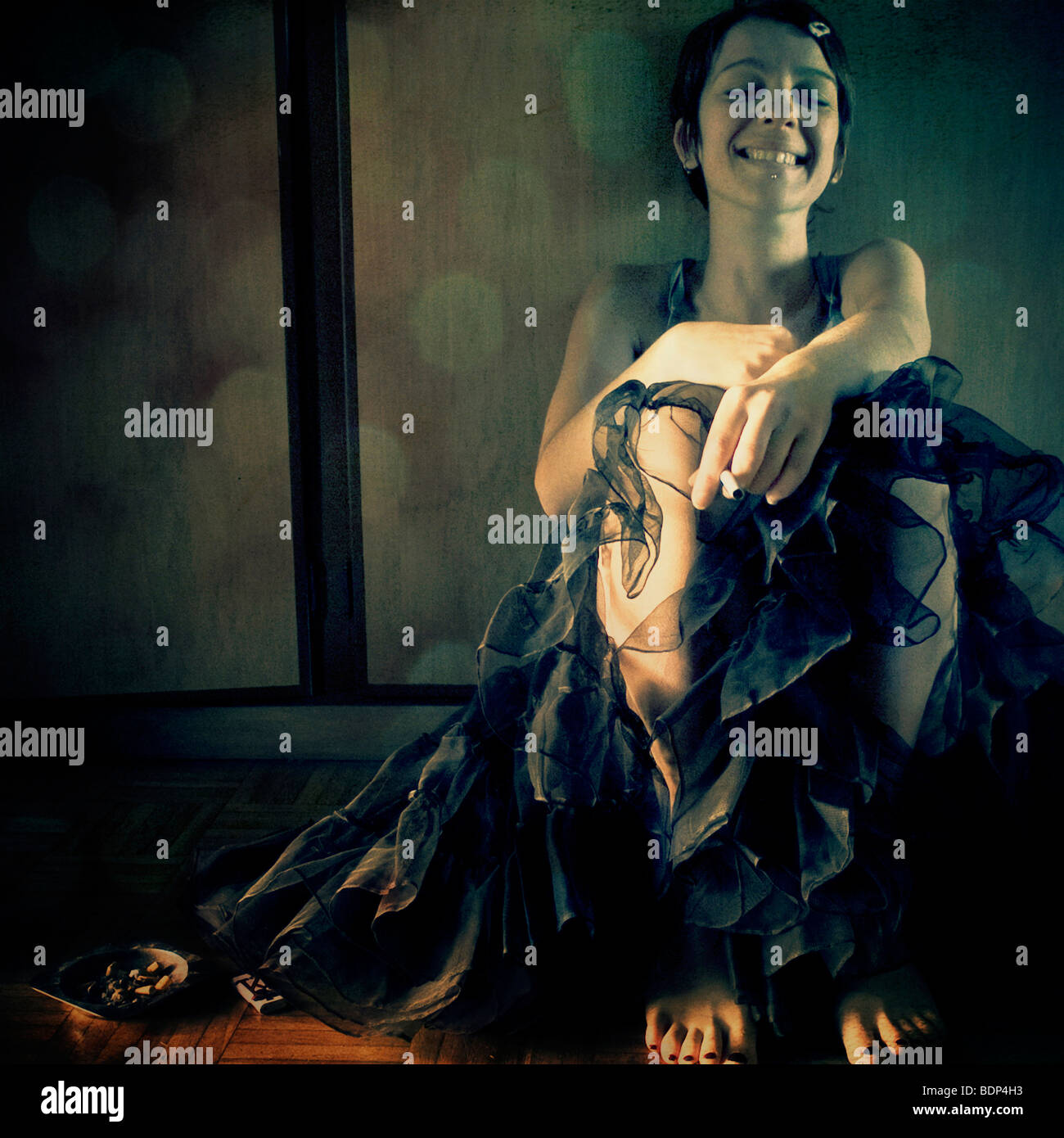 a young woman sitting on the floor and smiling at the camera with her ...