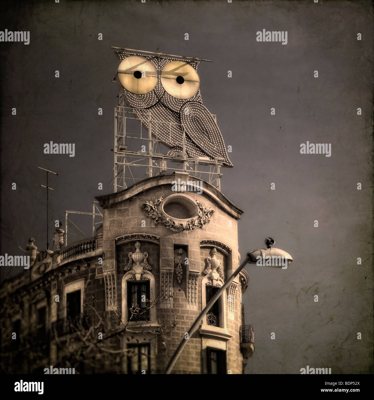An illuminated owl on a roof of an ornate building Stock Photo Alamy