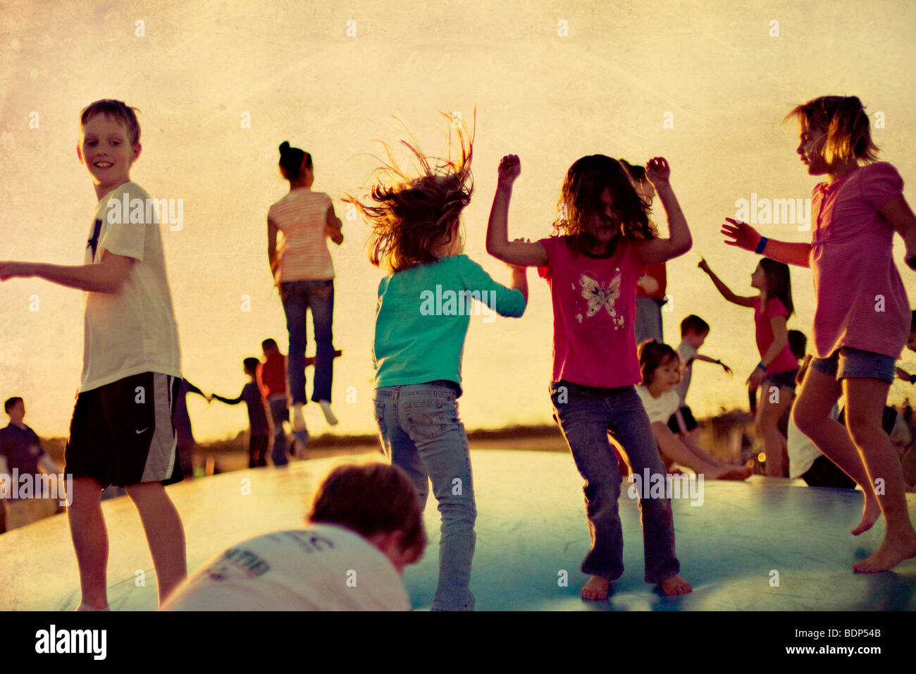 A group of young children jumping Stock Photo - Alamy