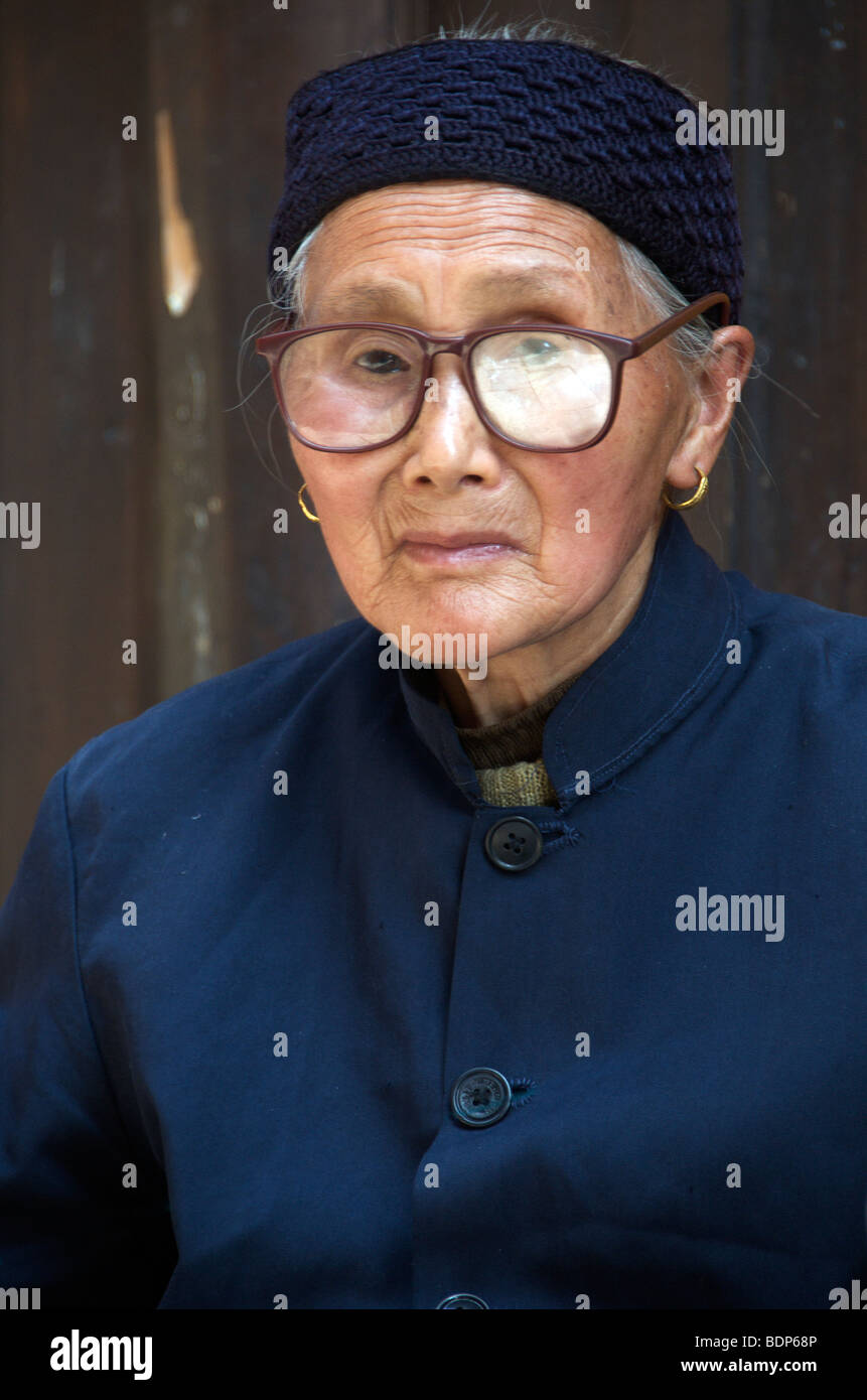 Portrait elderly woman wearing spectacles Old Furong Town Hunan Province China Stock Photo