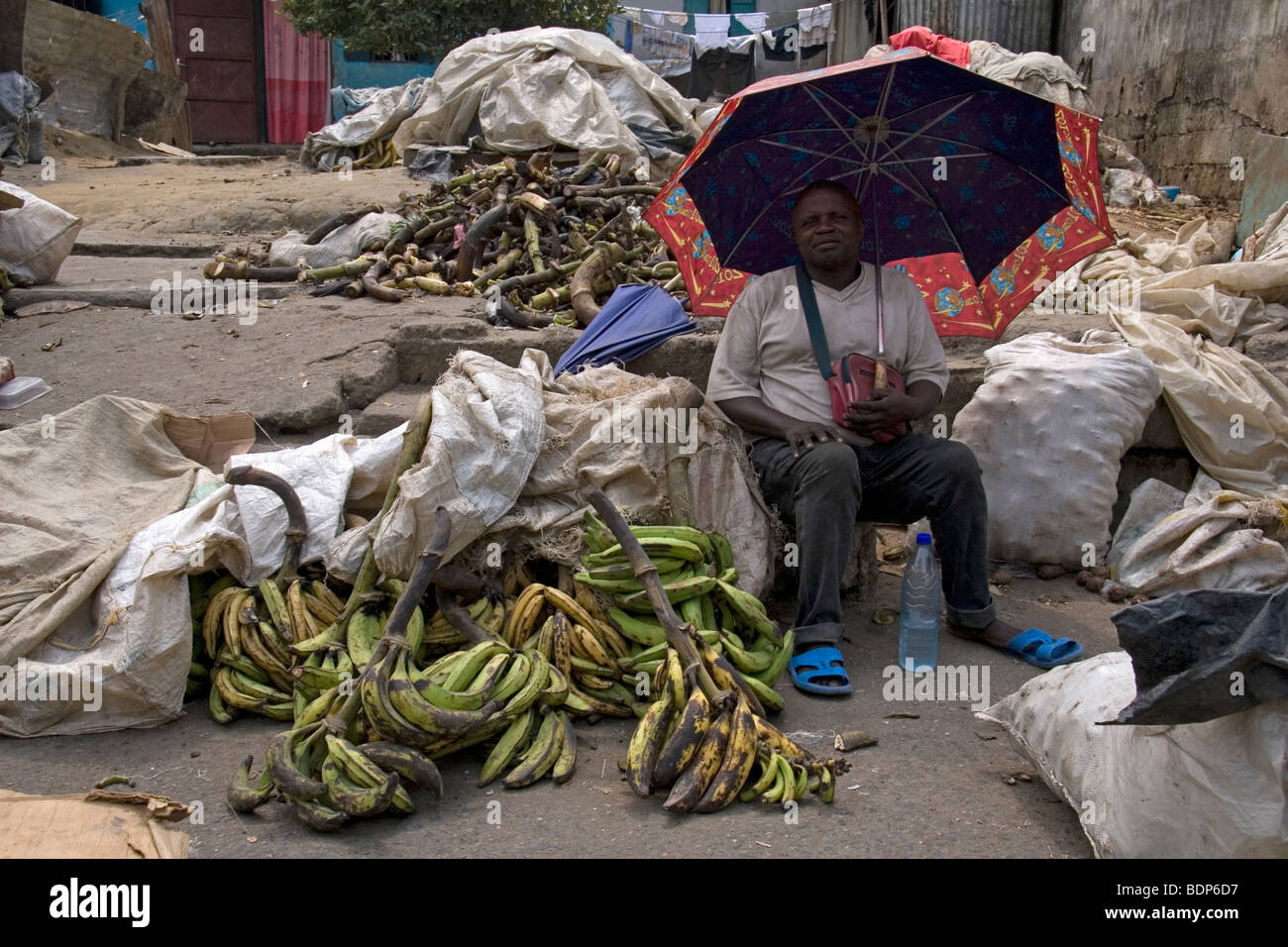 Woman selling plantain at street market in poor neighborhood of Grand Moulin Douala Cameroon West Africa Stock Photo