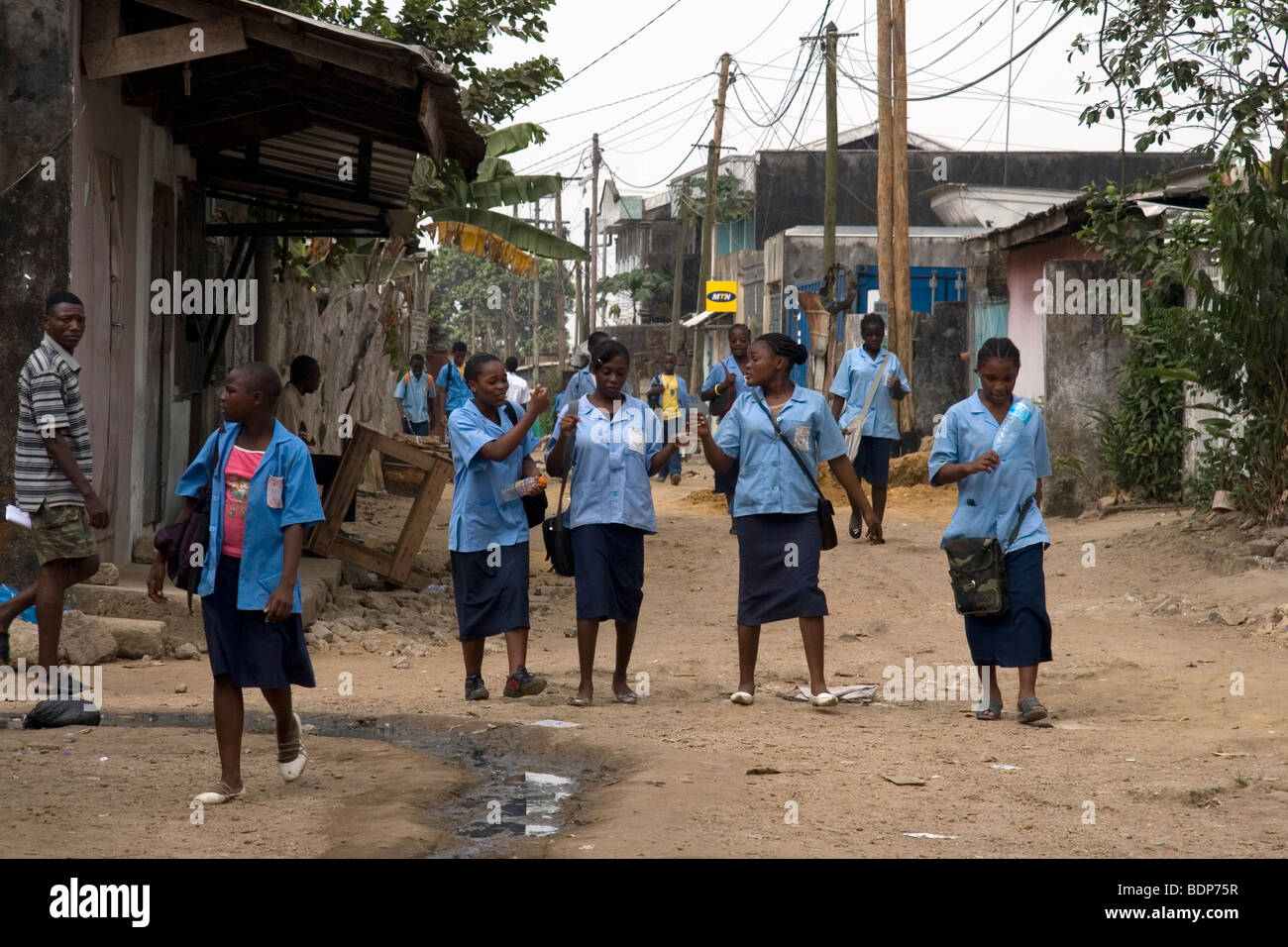 High school girls in uniform going to school in poor neighborhood of Grand Moulin Douala Cameroon West Africa Stock Photo
