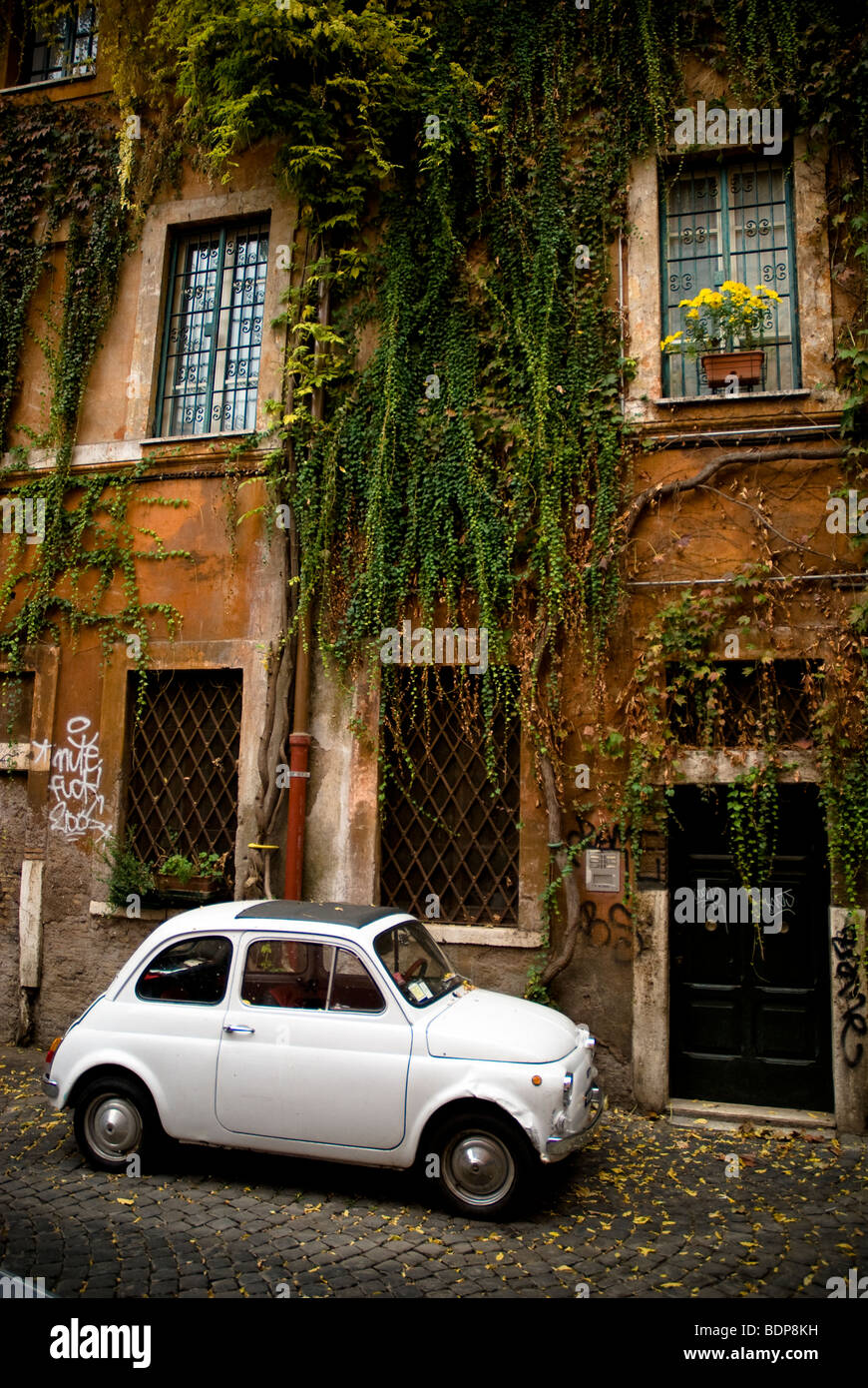 White Fiat 500 Bambino, parked in cobble stoned street in Trastevere, district of Rome, Italy Stock Photo