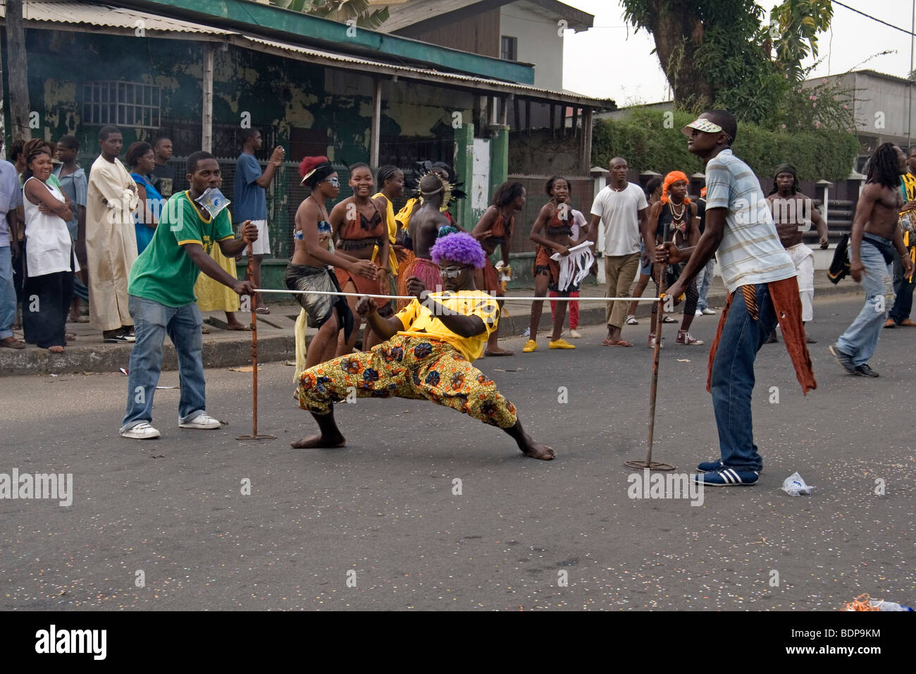Man in fancy dress doing limbo dance in Carnival parade Bonapriso district  Douala Cameroon West Africa Stock Photo - Alamy