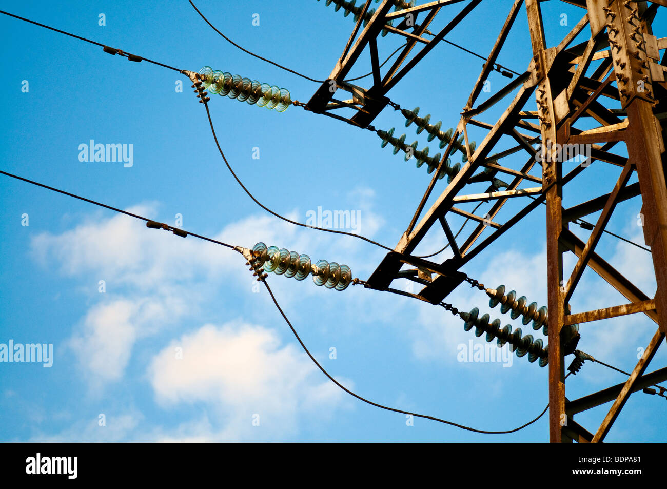 High voltage tower against a blue sky with clouds Stock Photo - Alamy