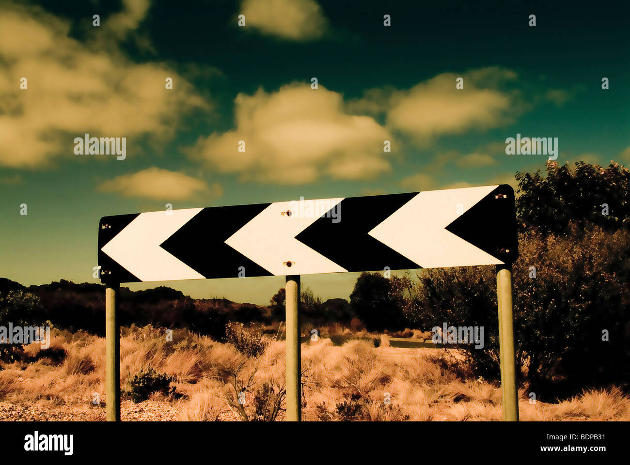 A road sign under a cloudy sky Stock Photo - Alamy