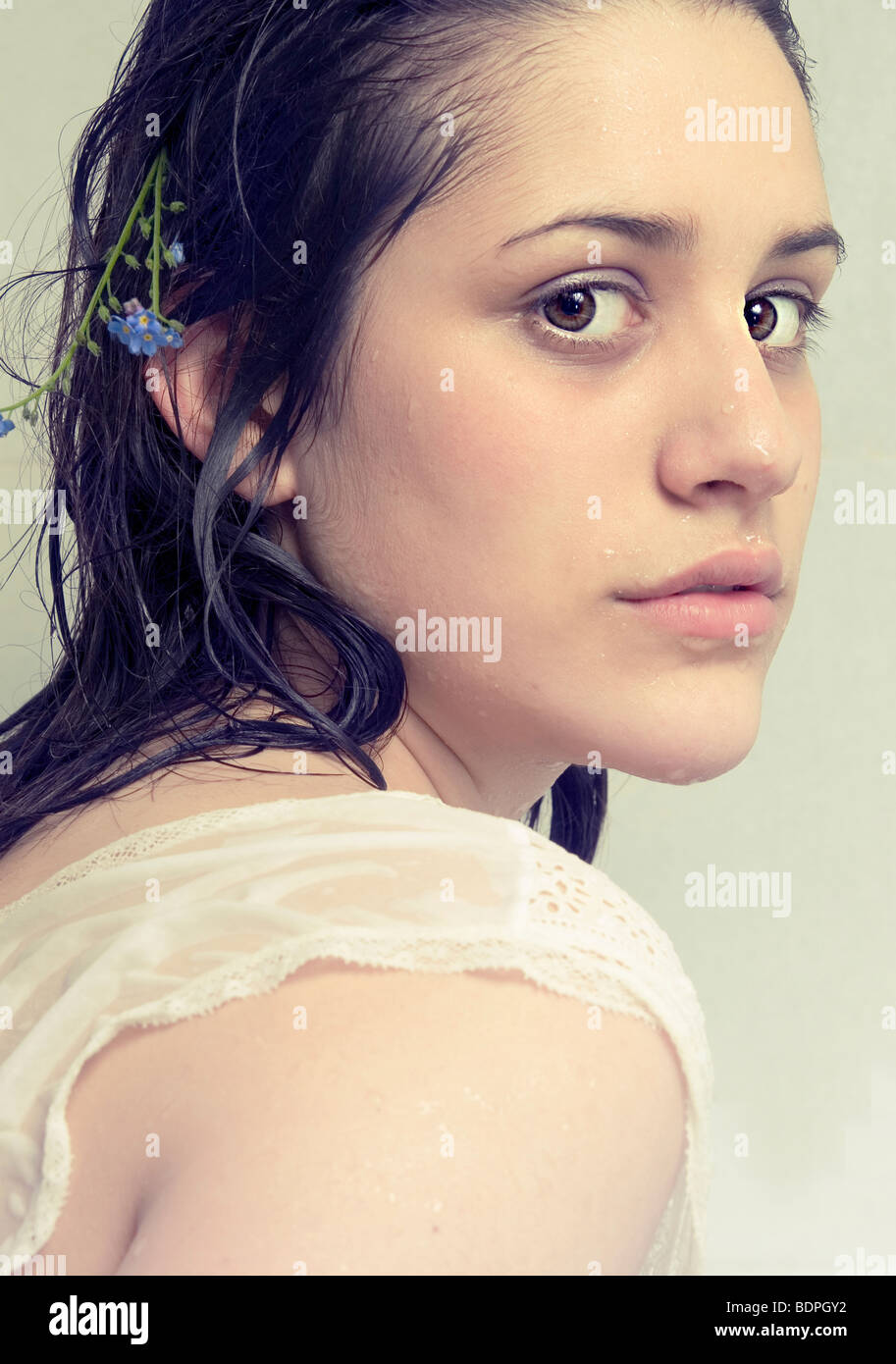 A young girl with dark wet hair looking at the camera Stock Photo
