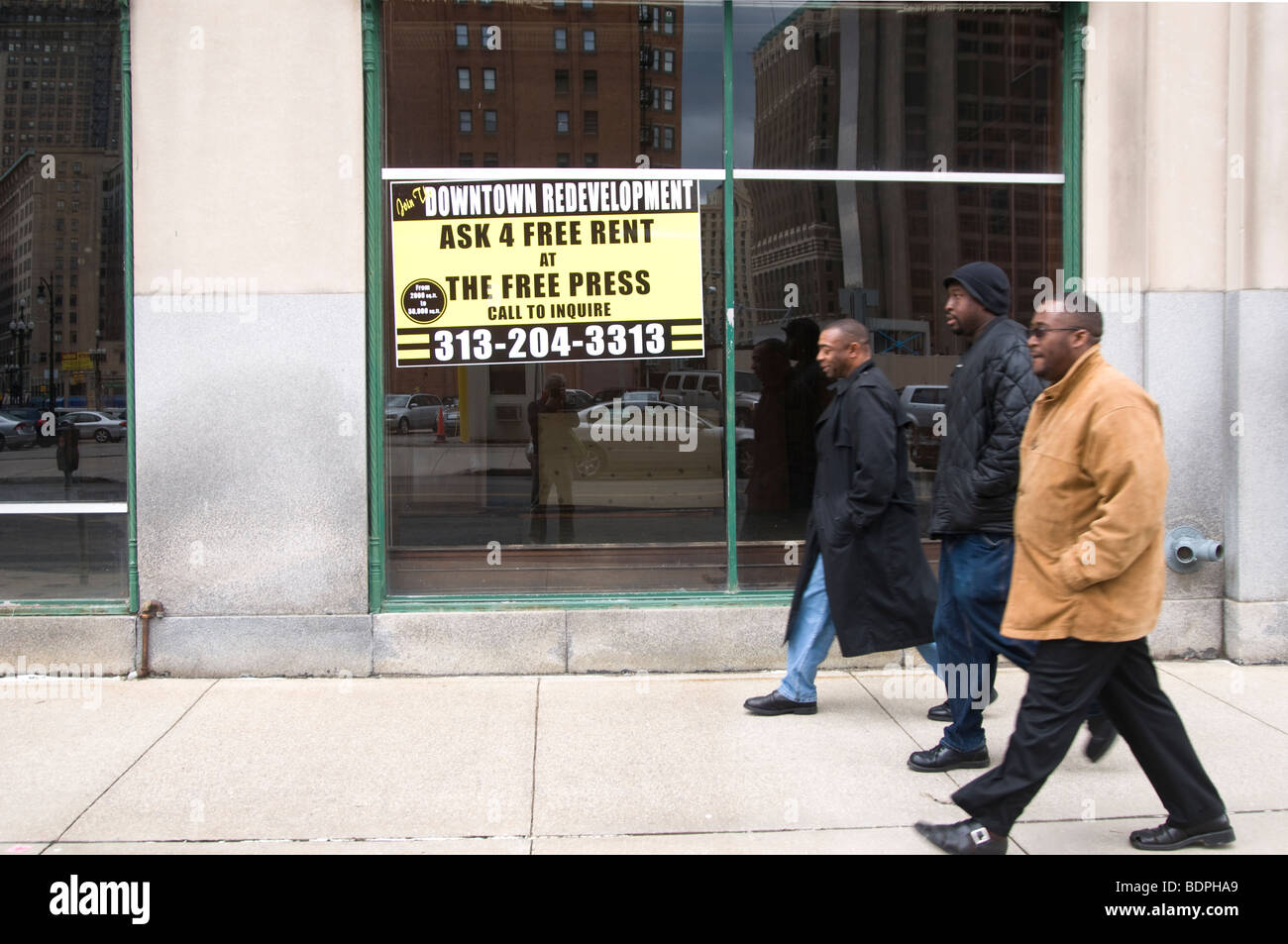 Detroit downtown development program, three African American men crossing office to be rented Stock Photo