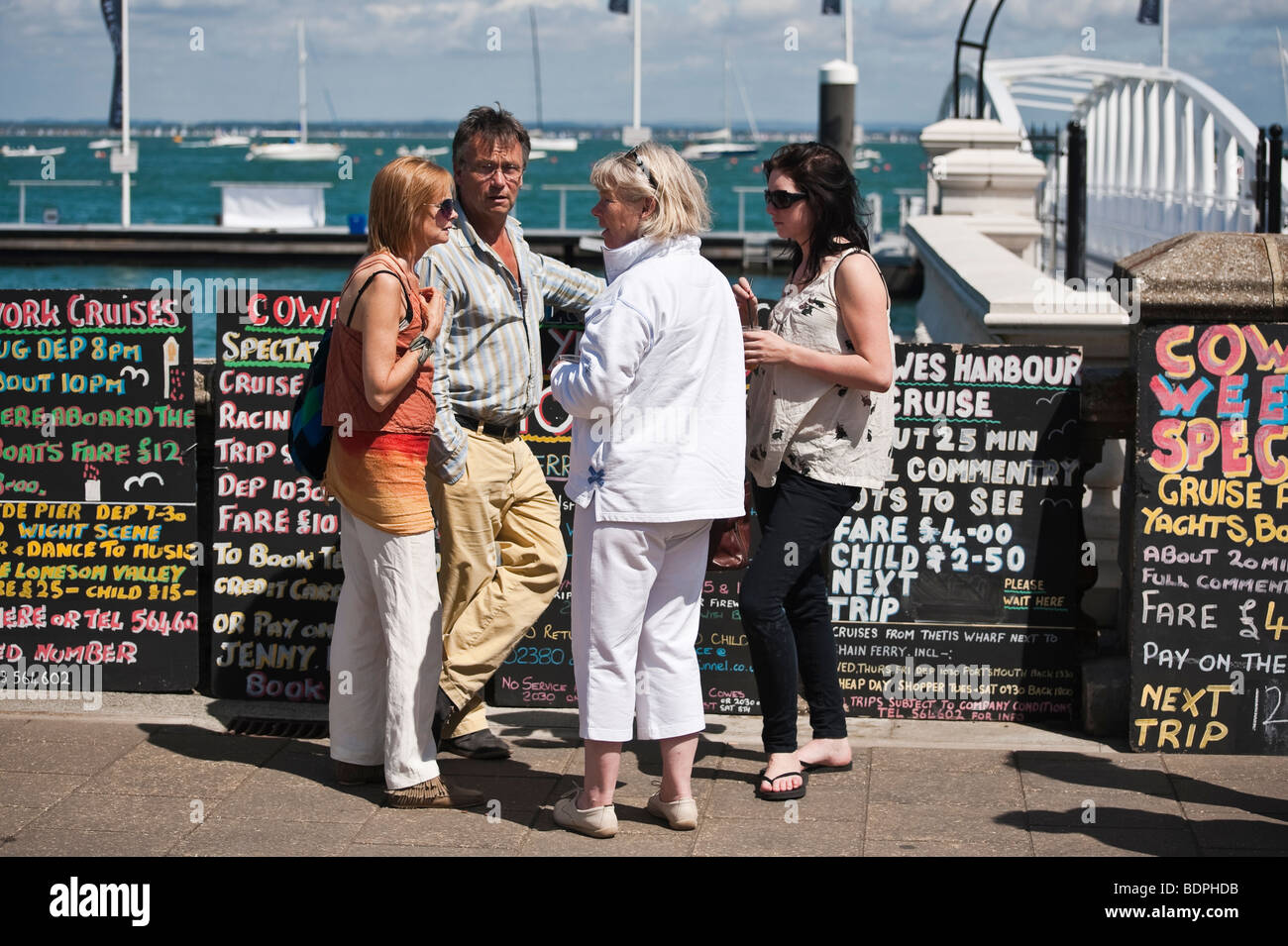 Tourists wait for a sightseeing tour boat at Cowes week sailing regatta, 2009, Isle of Wight, England, UK Stock Photo