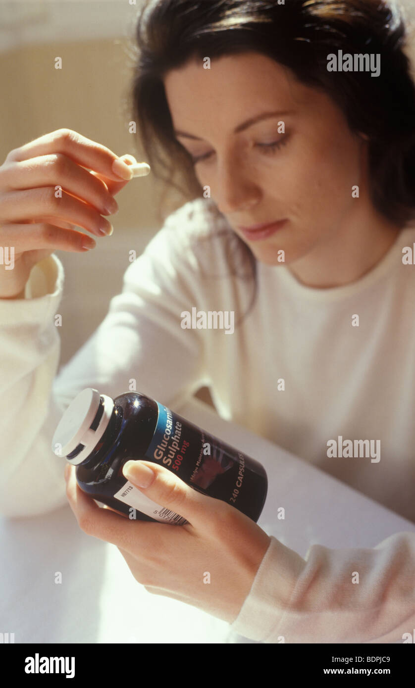 woman taking glucosamine sulphate supplements Stock Photo