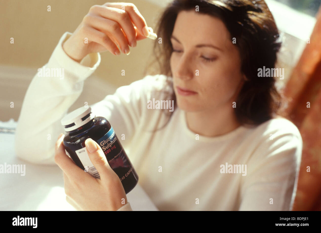 woman taking glucosamine sulphate supplements Stock Photo