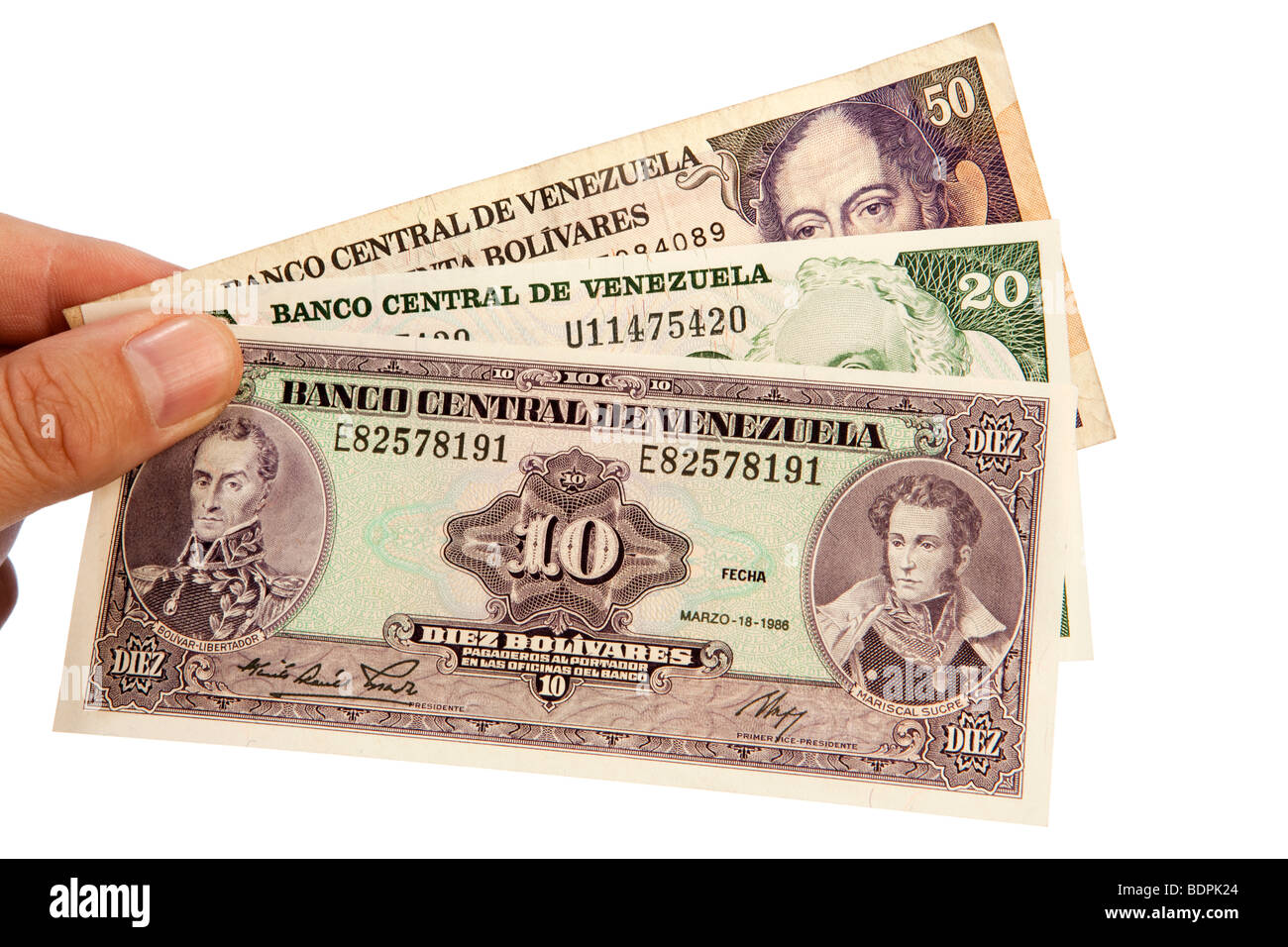 Money male hands holding handful of Venezuelan currency Stock Photo