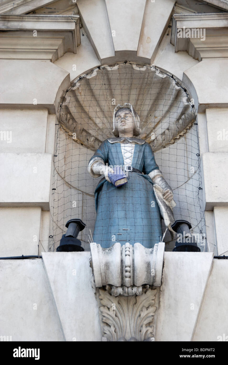 Statue of female Blue Coat pupil on exterior of Sir John Cass's Foundation Primary School in Aldgate, London, England, UK. Stock Photo