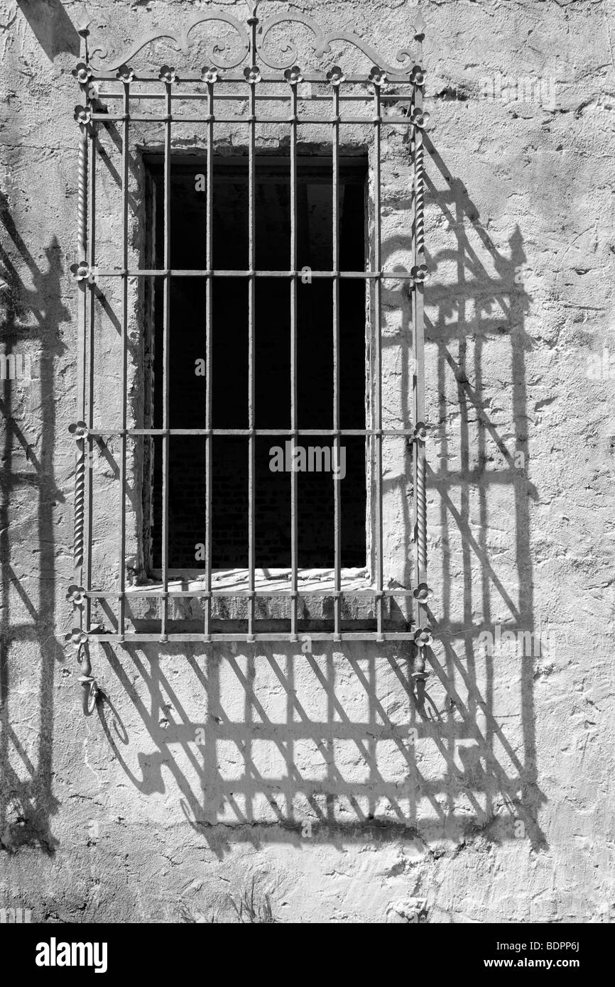 An old window with decorative iron bars Stock Photo